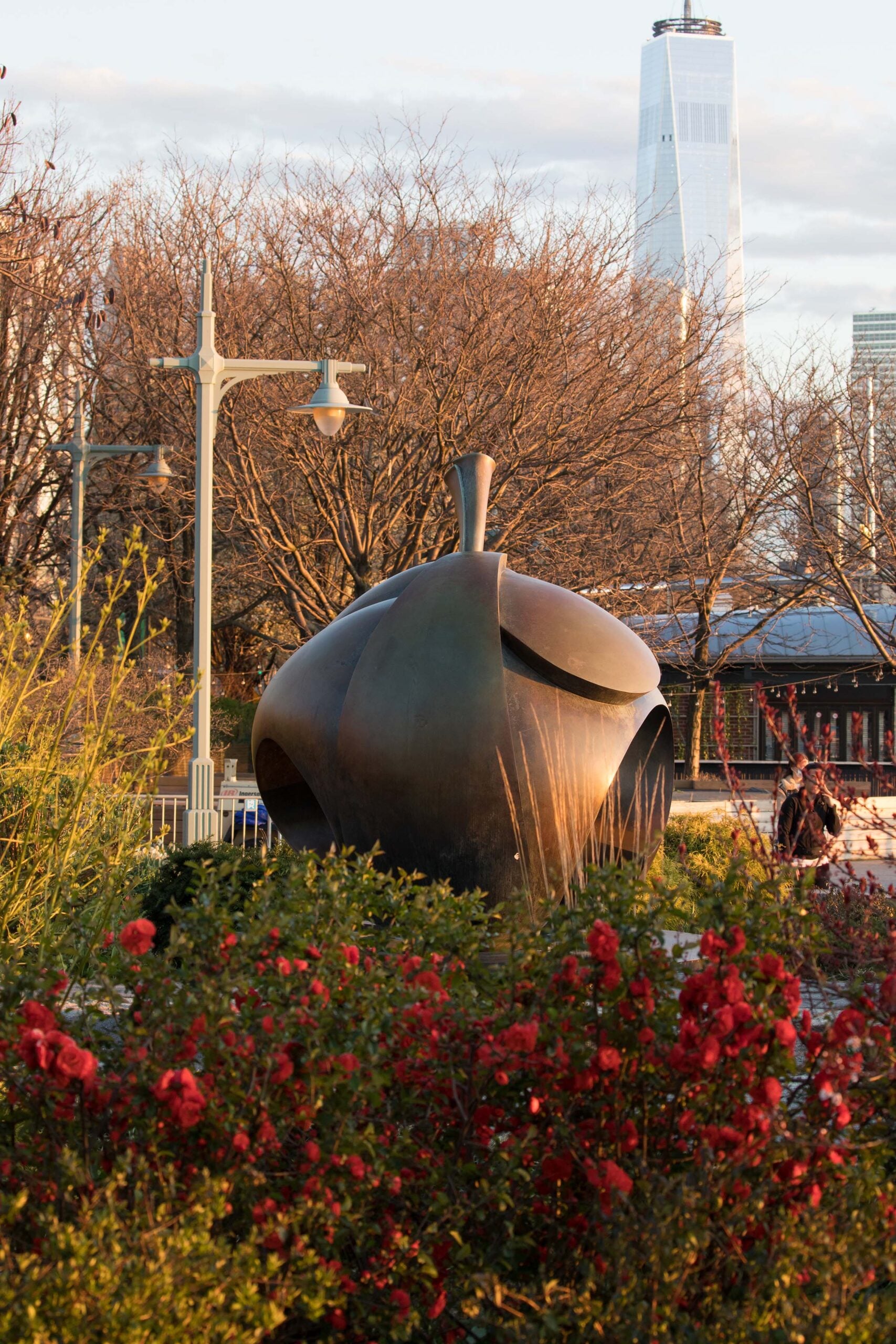 The sun sets as the Apple statue faces to the Hudson River