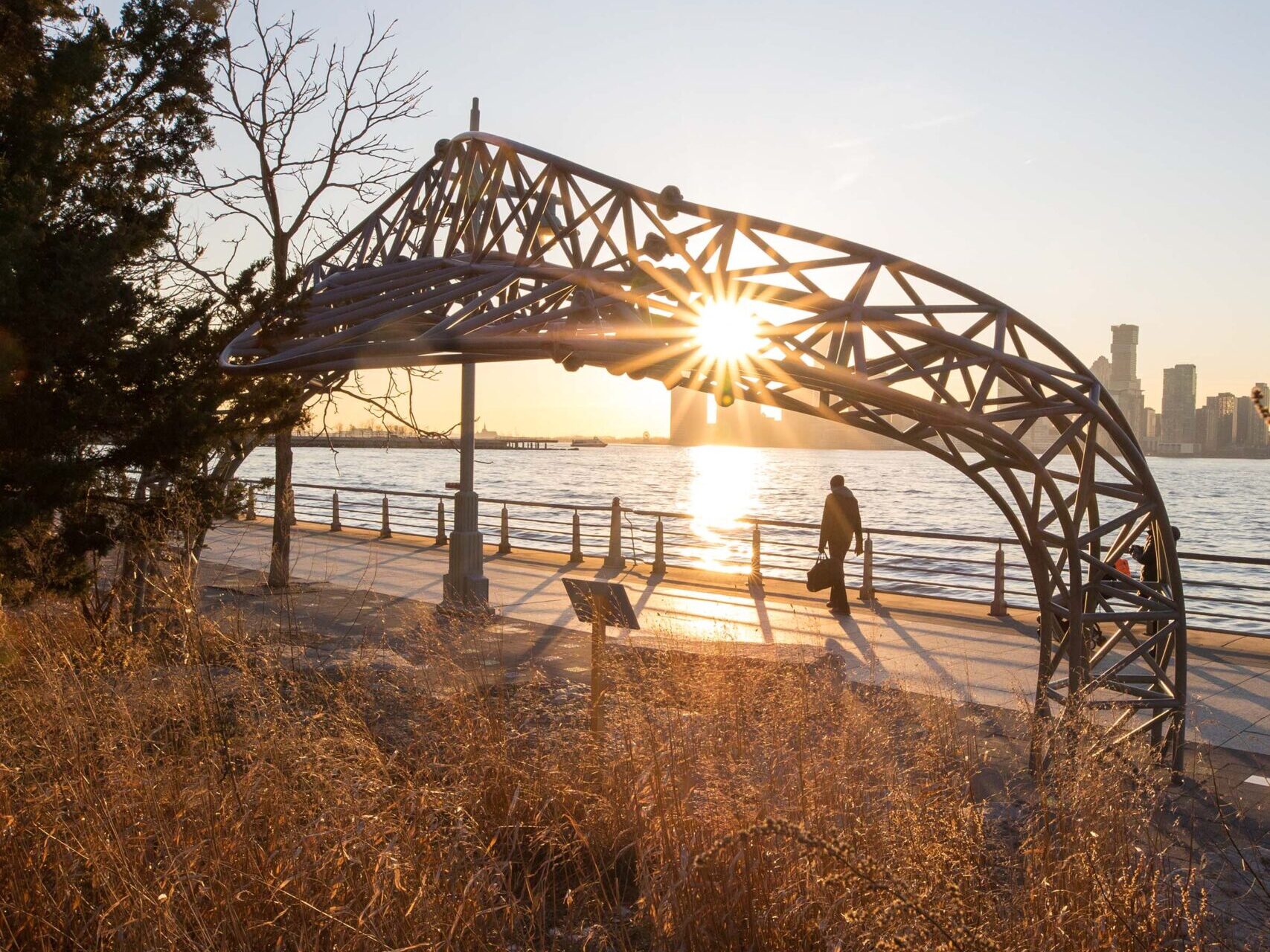 The sunset is seen through the serpentine structures