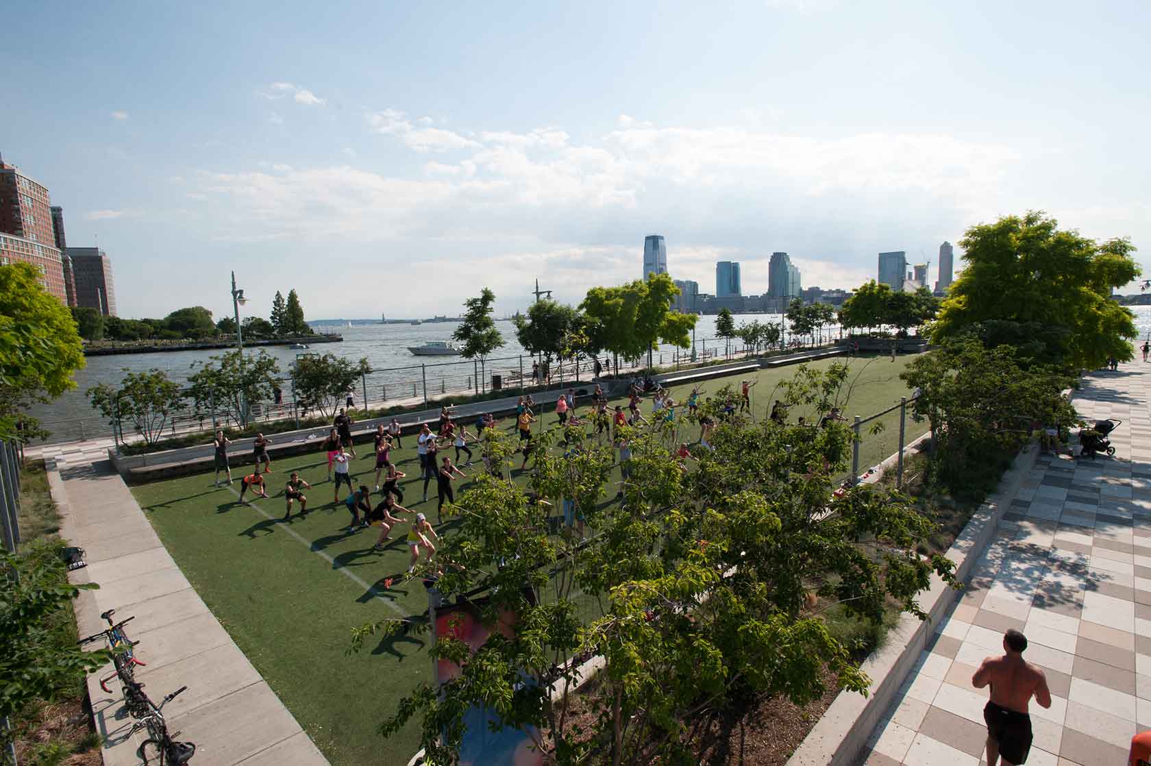 Park visitors taking part in a group fitness class on the Pier 25 turf field