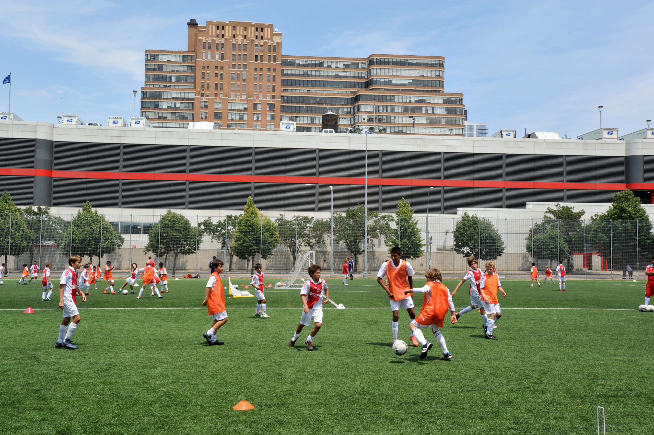 Soccer groups kick the ball on the Chelsea Waterside Park field