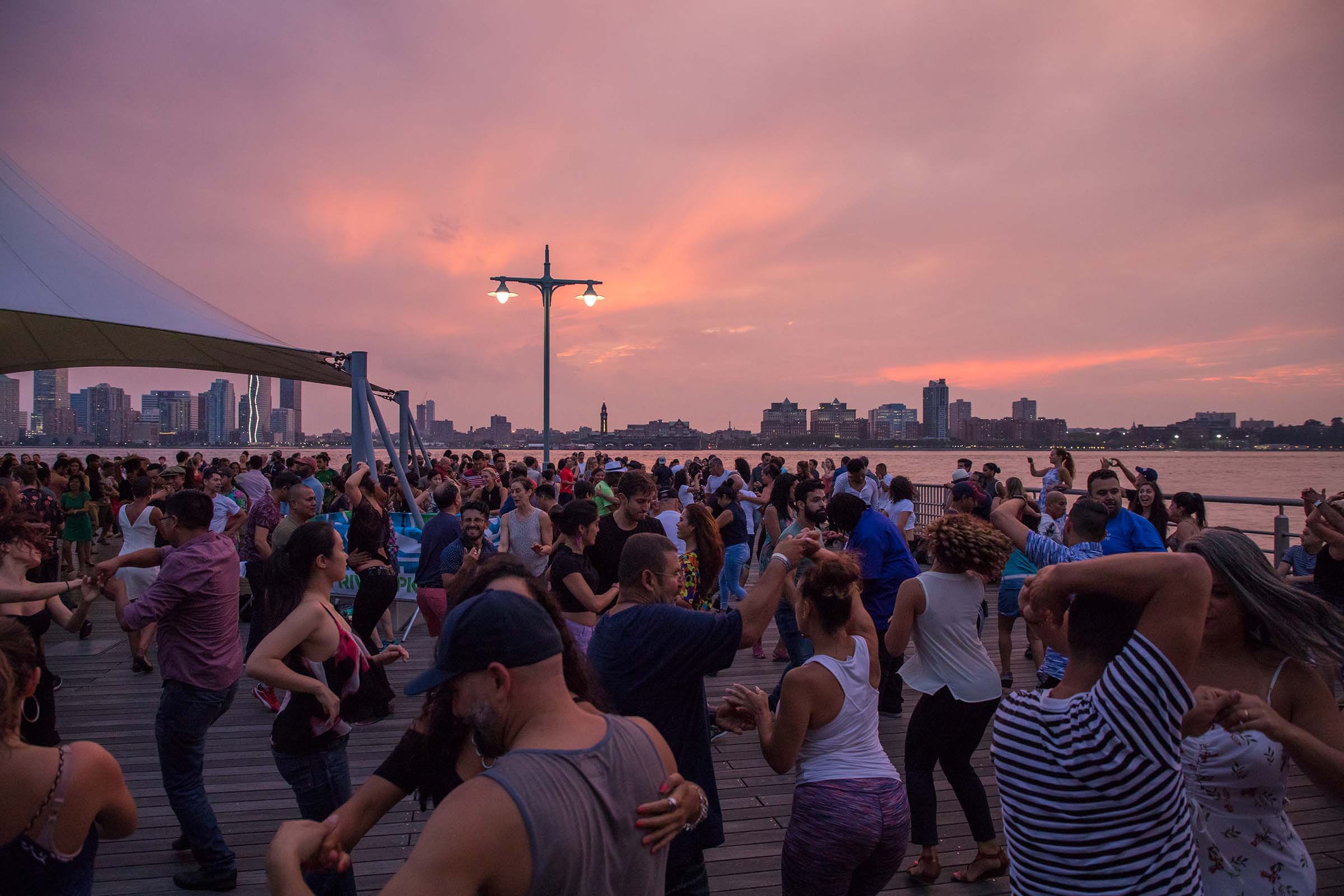 The redish pink sky is the perfect backdrop for Sunset Salsa with Talia
