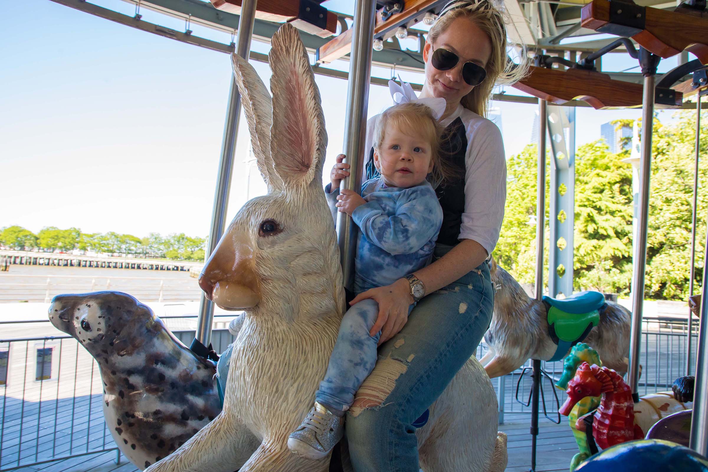 Kids and adults enjoy a ride on the carousel at Pier 62