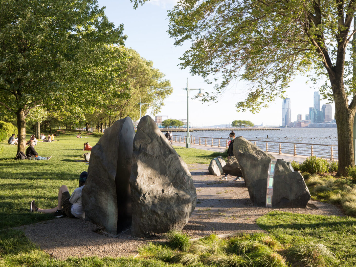 People lounging near the LGBT memorial at Hudson River Park