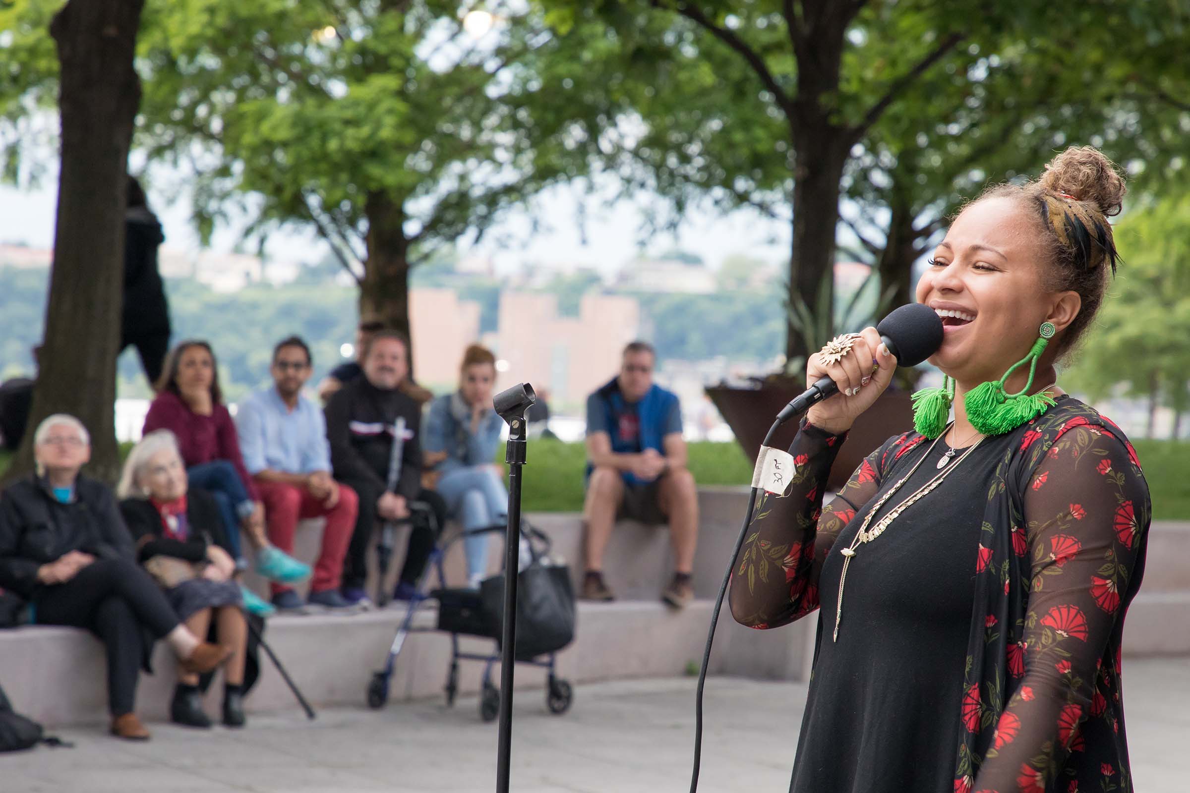 Smiling, a jazz singer hits her notes as the audience watches