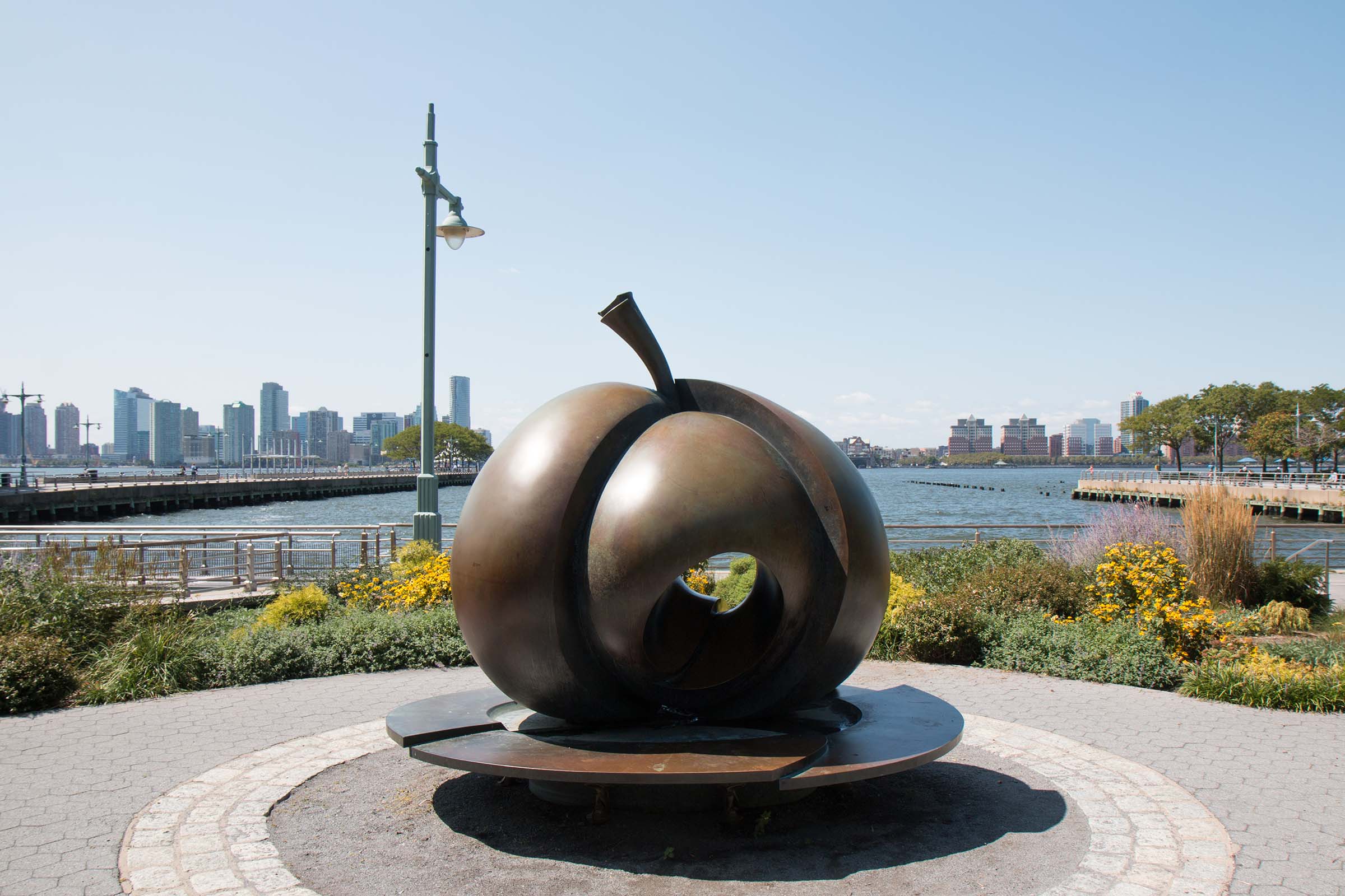 The bronze statue of an Apple sits in the center of the Apple Garden