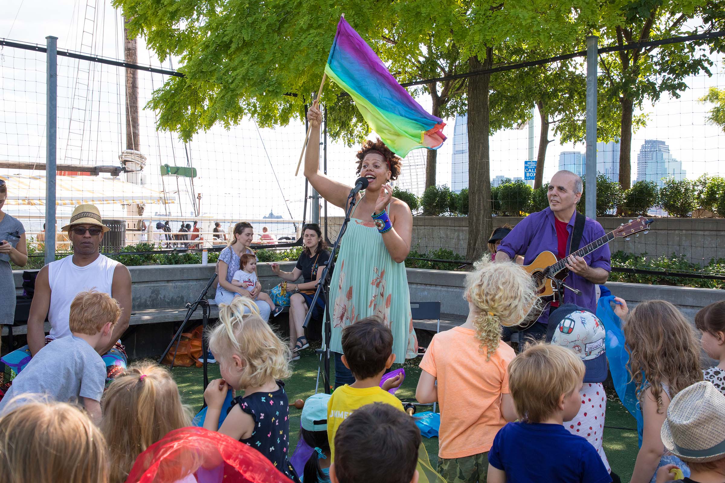 A rainbow flag is waving by the singer at RiverKids