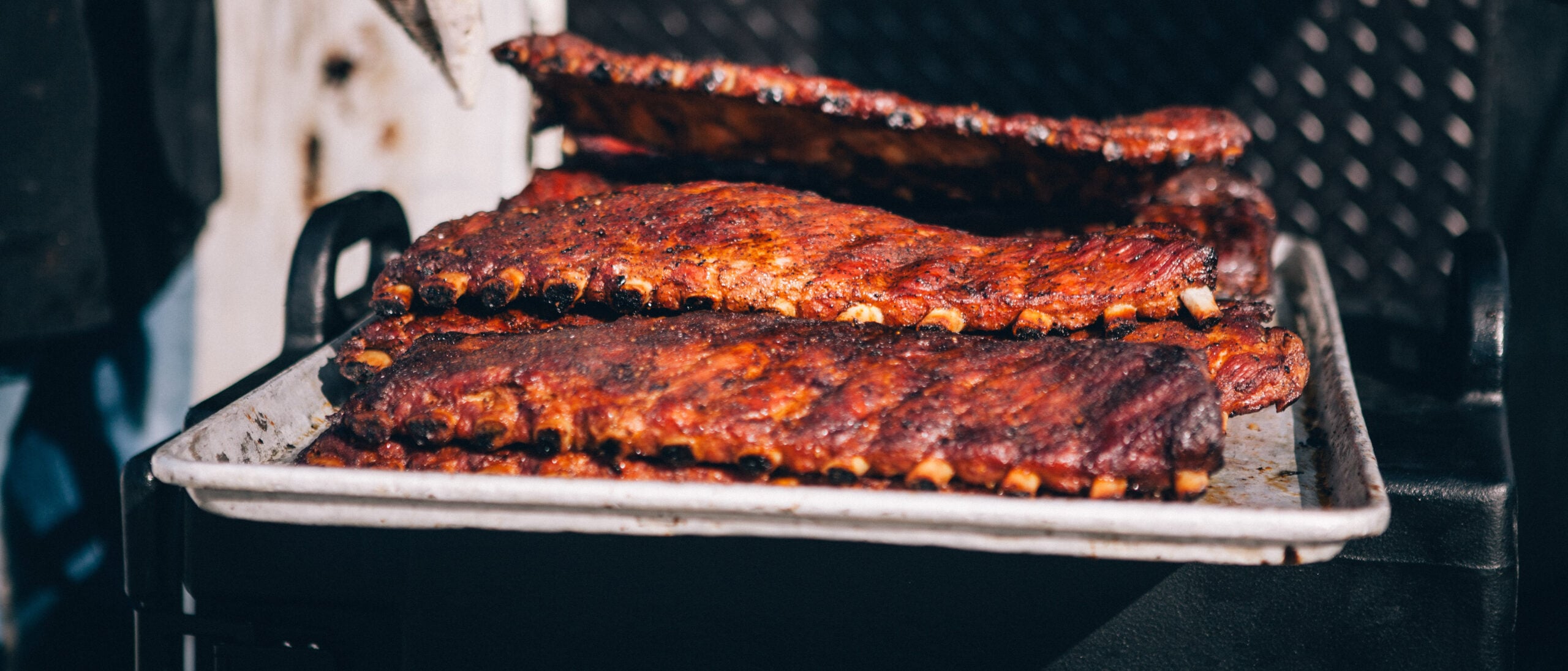 BBQ Ribs sit on the grill awaiting eager fans to eat