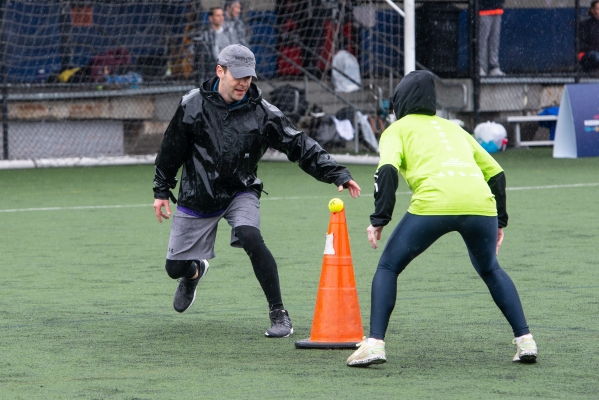 A player at HRPK Games tries to snatch the tennis ball from their competition