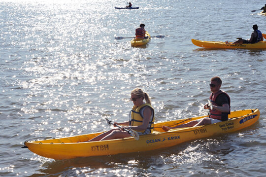 Kayakers from the Downtown Boathouse glide along the Hudson River