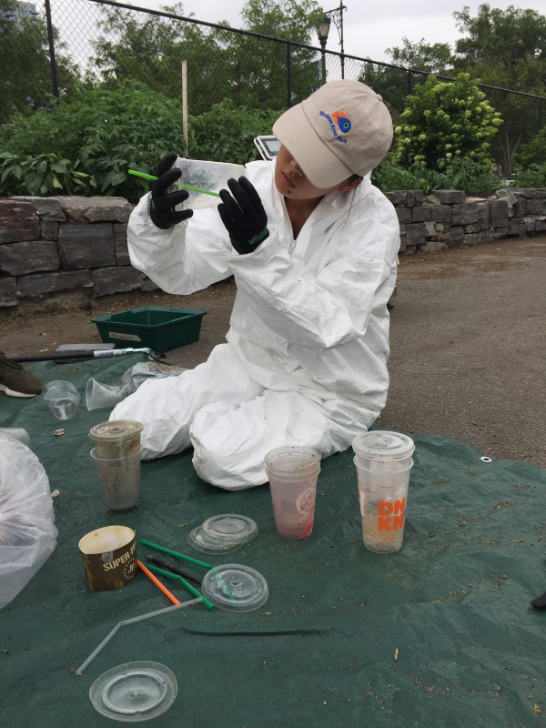 A Hudson River Park scientist examines some of the plastic found during a recent audit