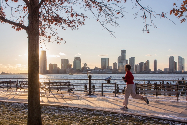 A jogger heading down the esplanade during sunset