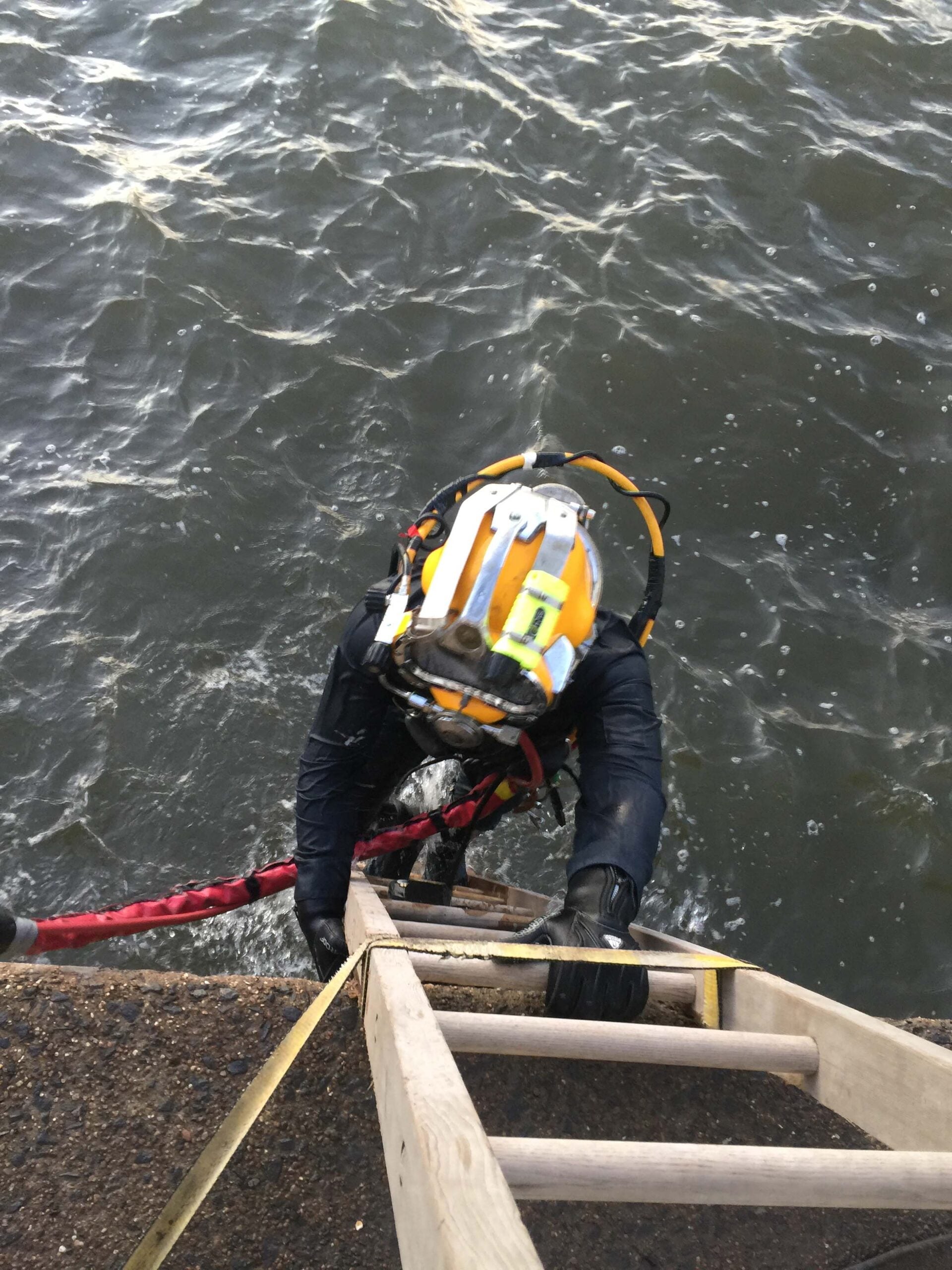 A scuba diver prepares to enter the river