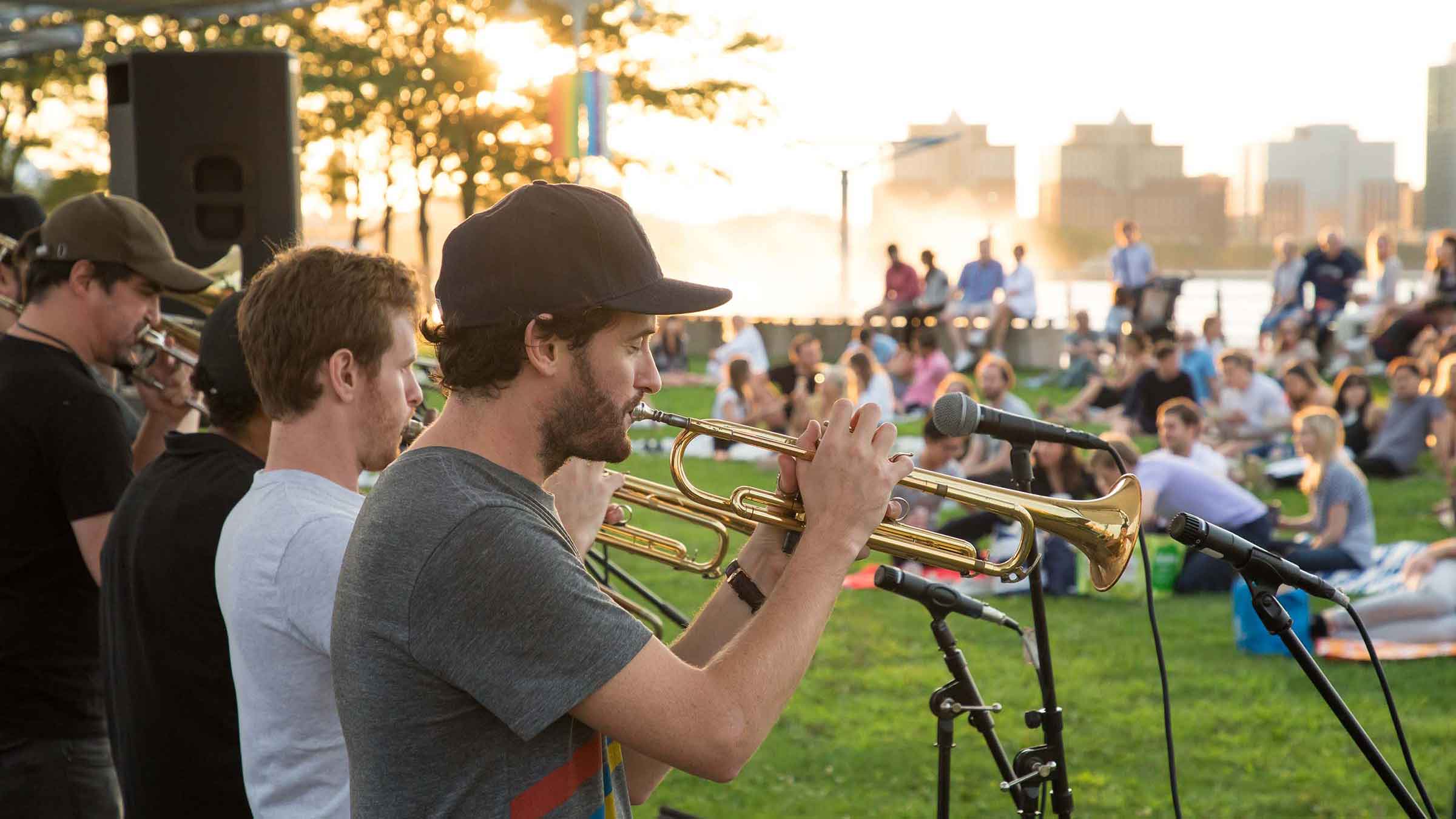 High and Mighty Brass Band playing their trumpets to the crowd