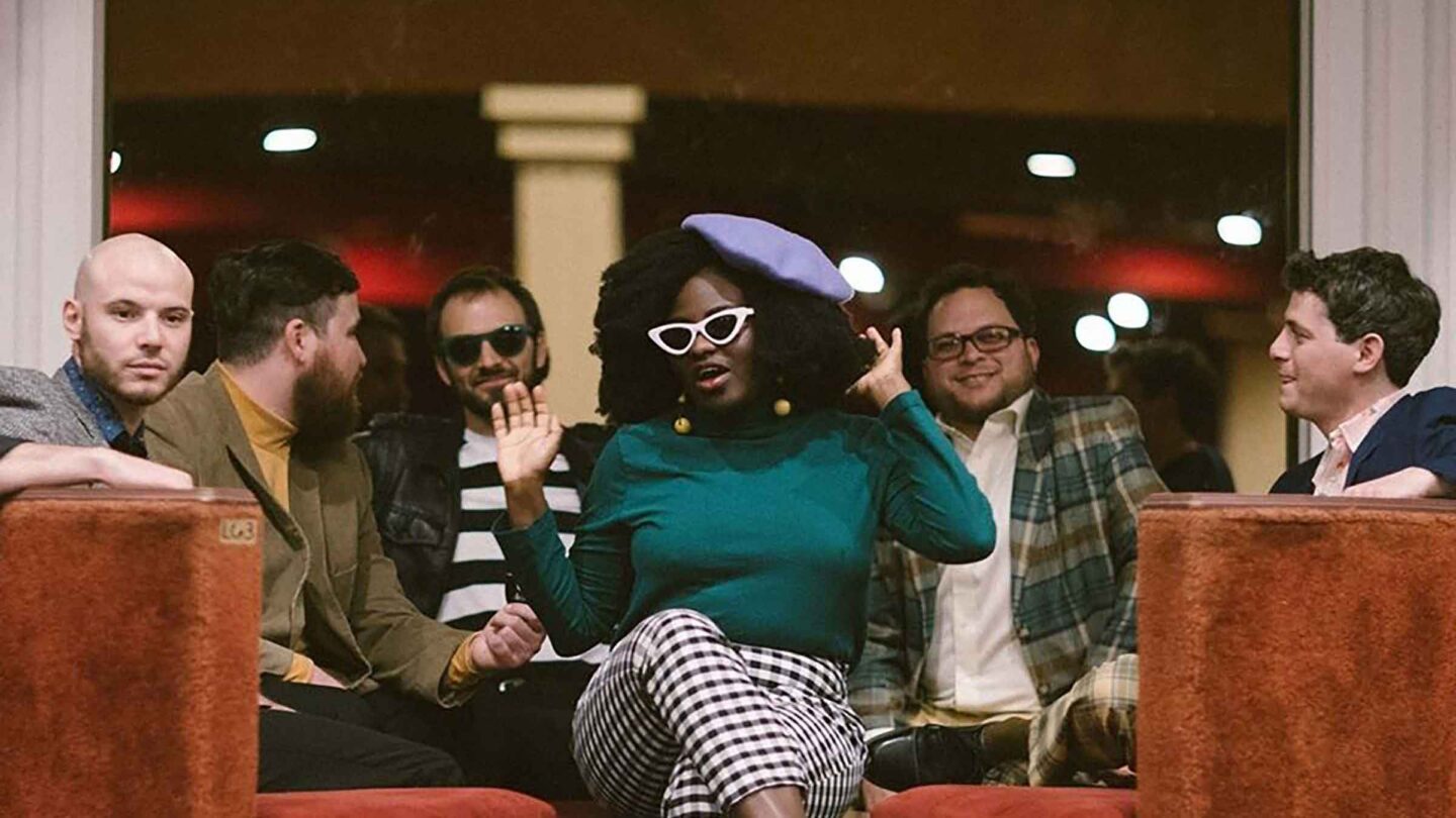 The group in the band The Big Takeover sits and relaxes on benches