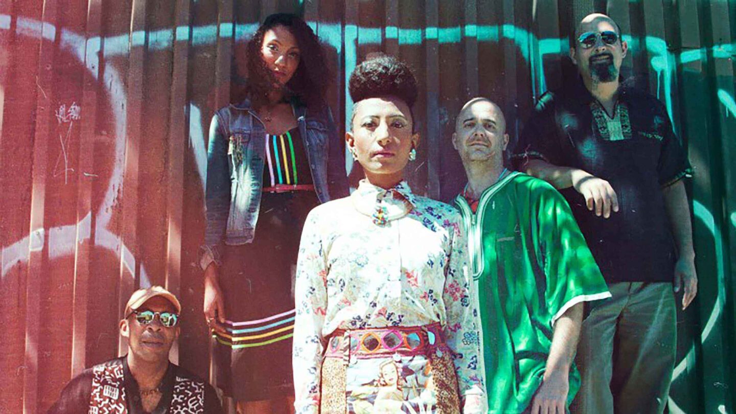 The vocal group Alsarah and the Nubatones, greens, whites and reds cover the photo
