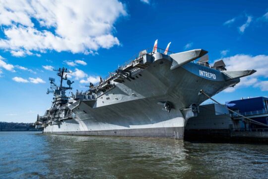 The intrepid space museum sitting on the river at Hudson River Park on Pier 86