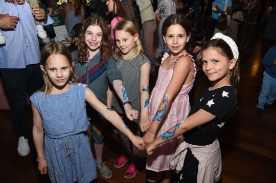 Girls show off their new dolphin tattoos at the bbq
