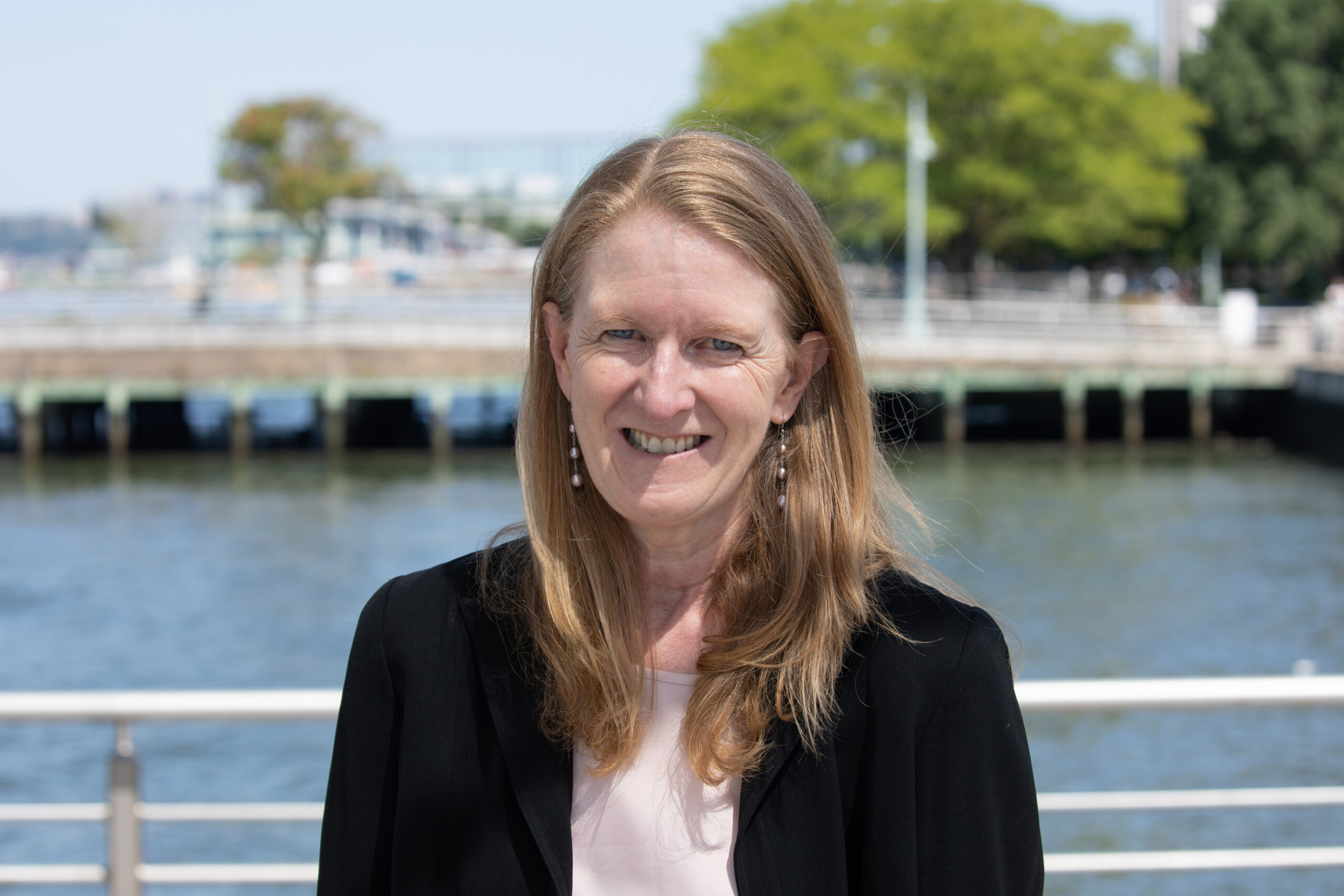 Professional headshot of Noreen Doyle on a Hudson River Park pier