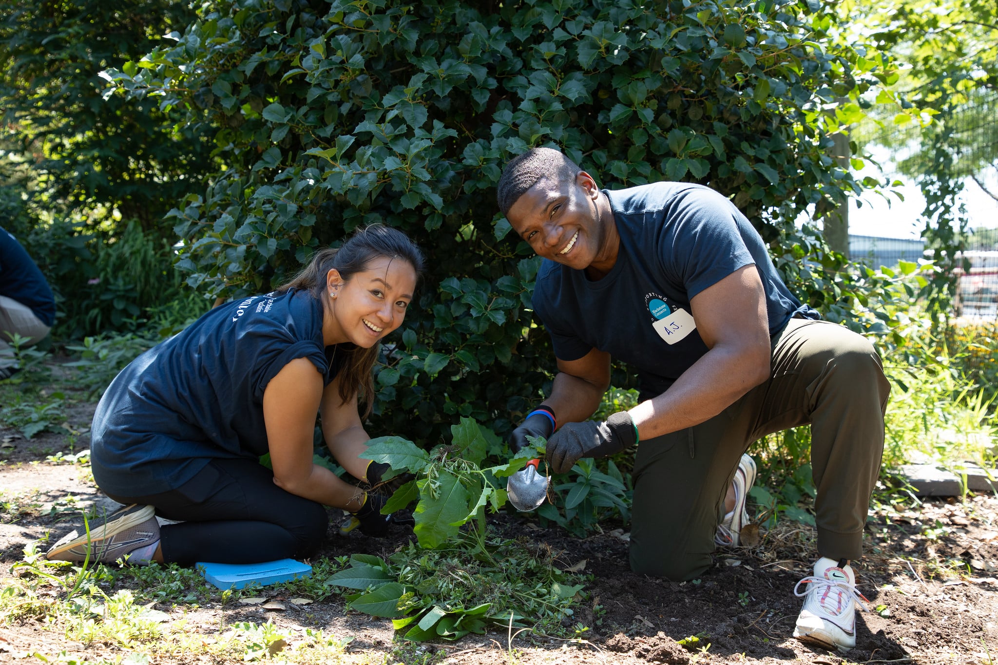 Two volunteers trim leaves in Hudson River Park