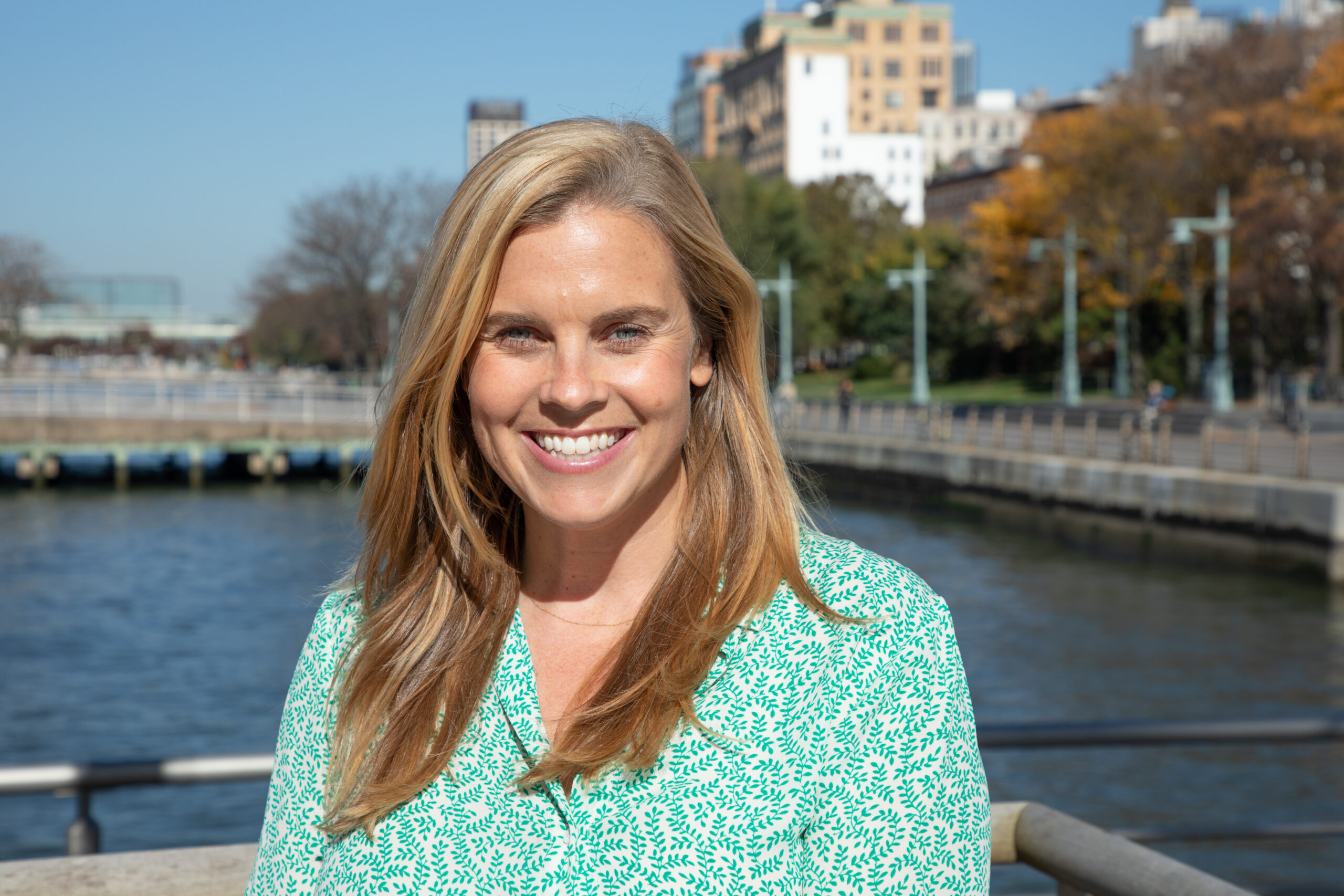 Professional headshot of Carrie Roble on a Hudson River Park pier