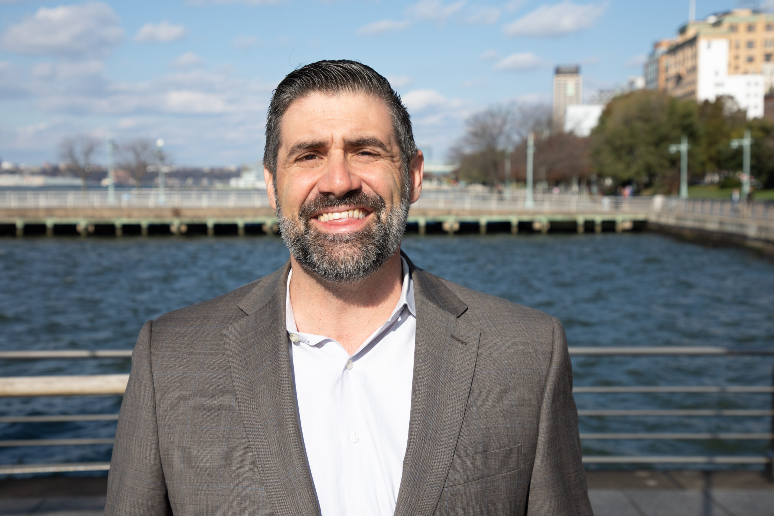 Professional headshot of Owen Davies on a Hudson River Park pier