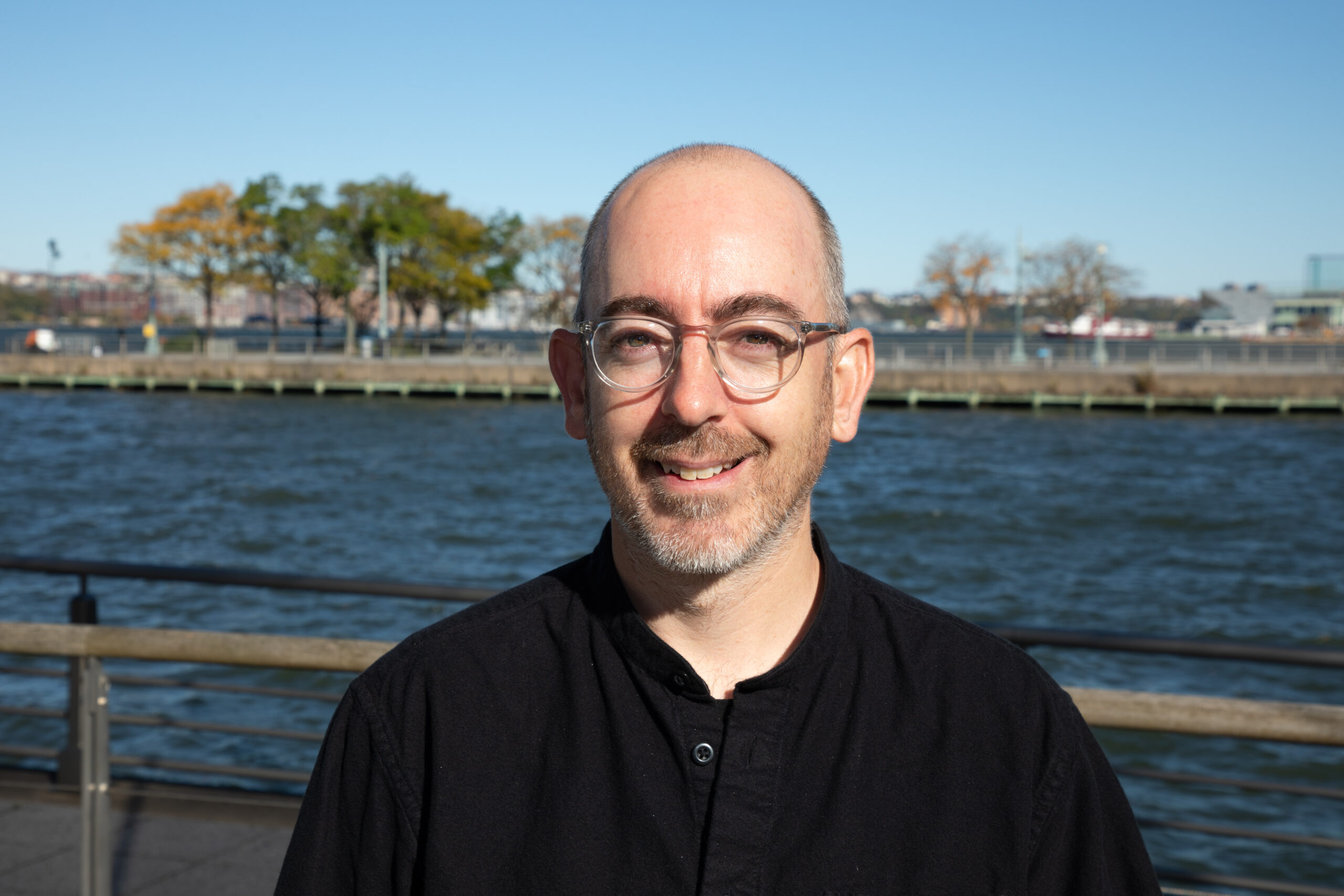Professional headshot of Kevin Quinn on a Hudson River Park pier