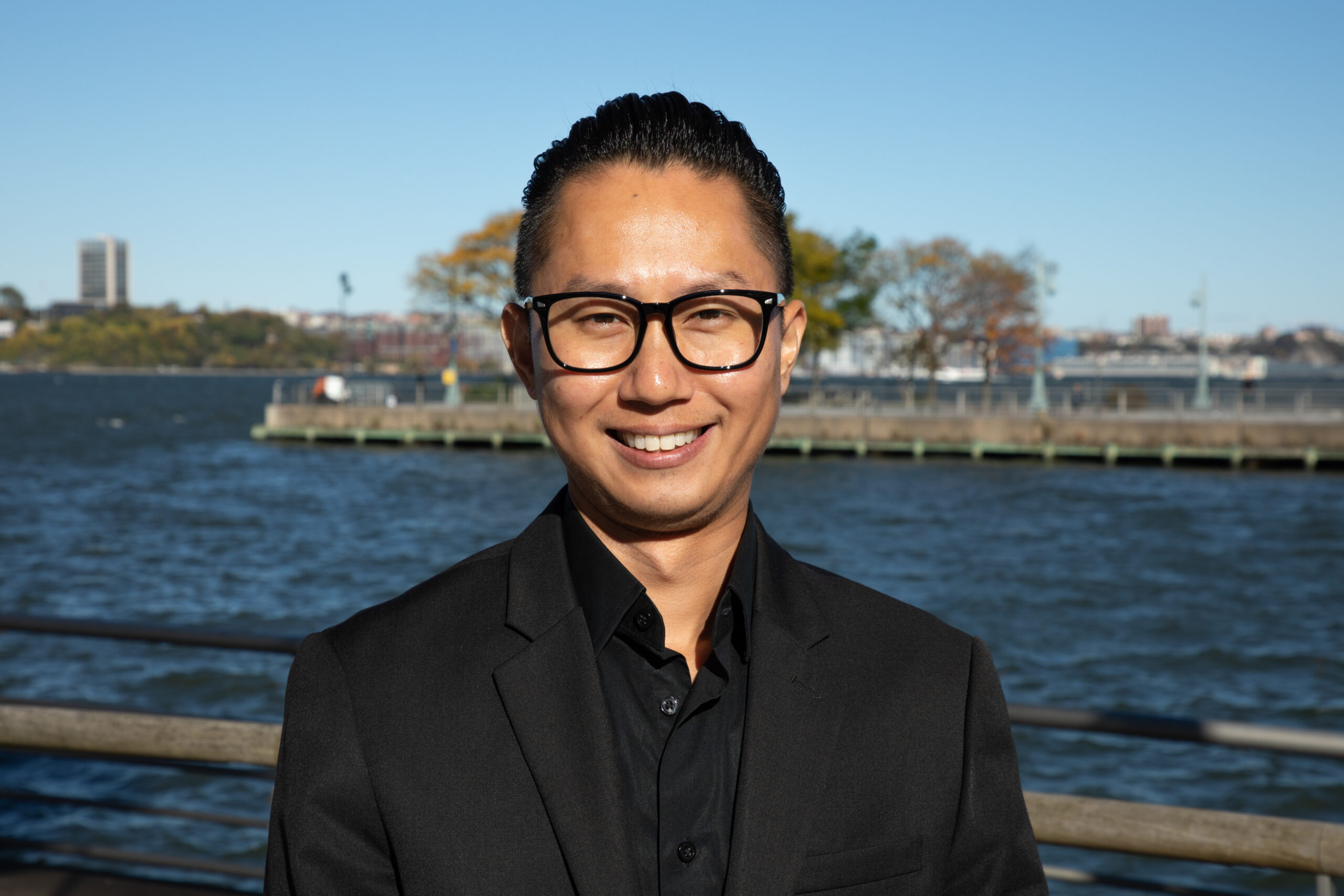 Professional headshot of Robert Nguyen on a Hudson River Park pier