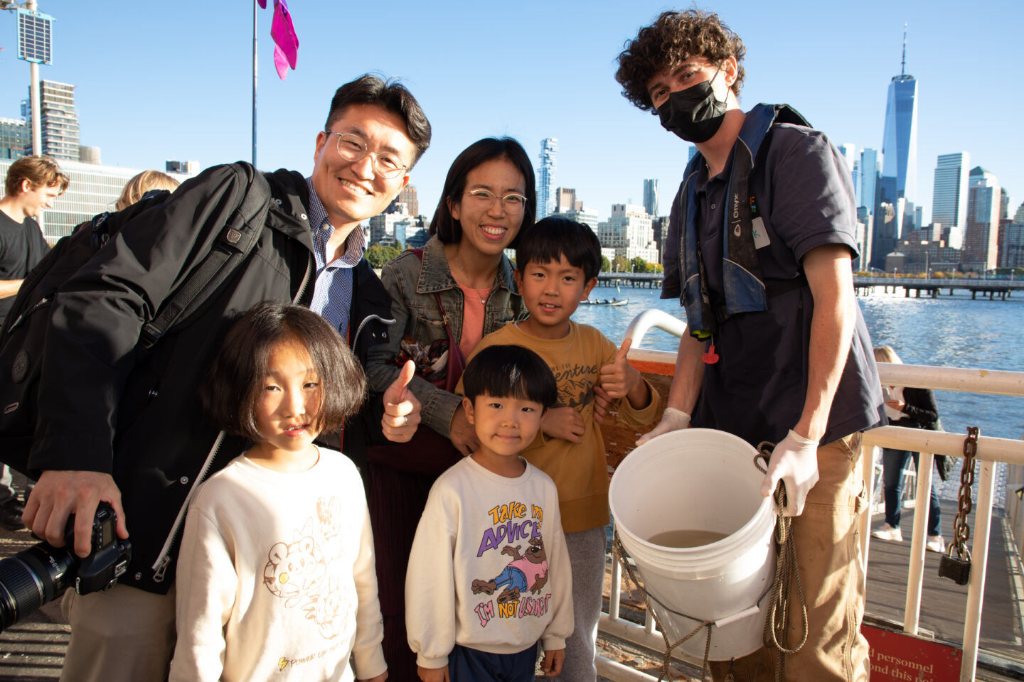 Release of the Fishes family poses with staff at Pier 40