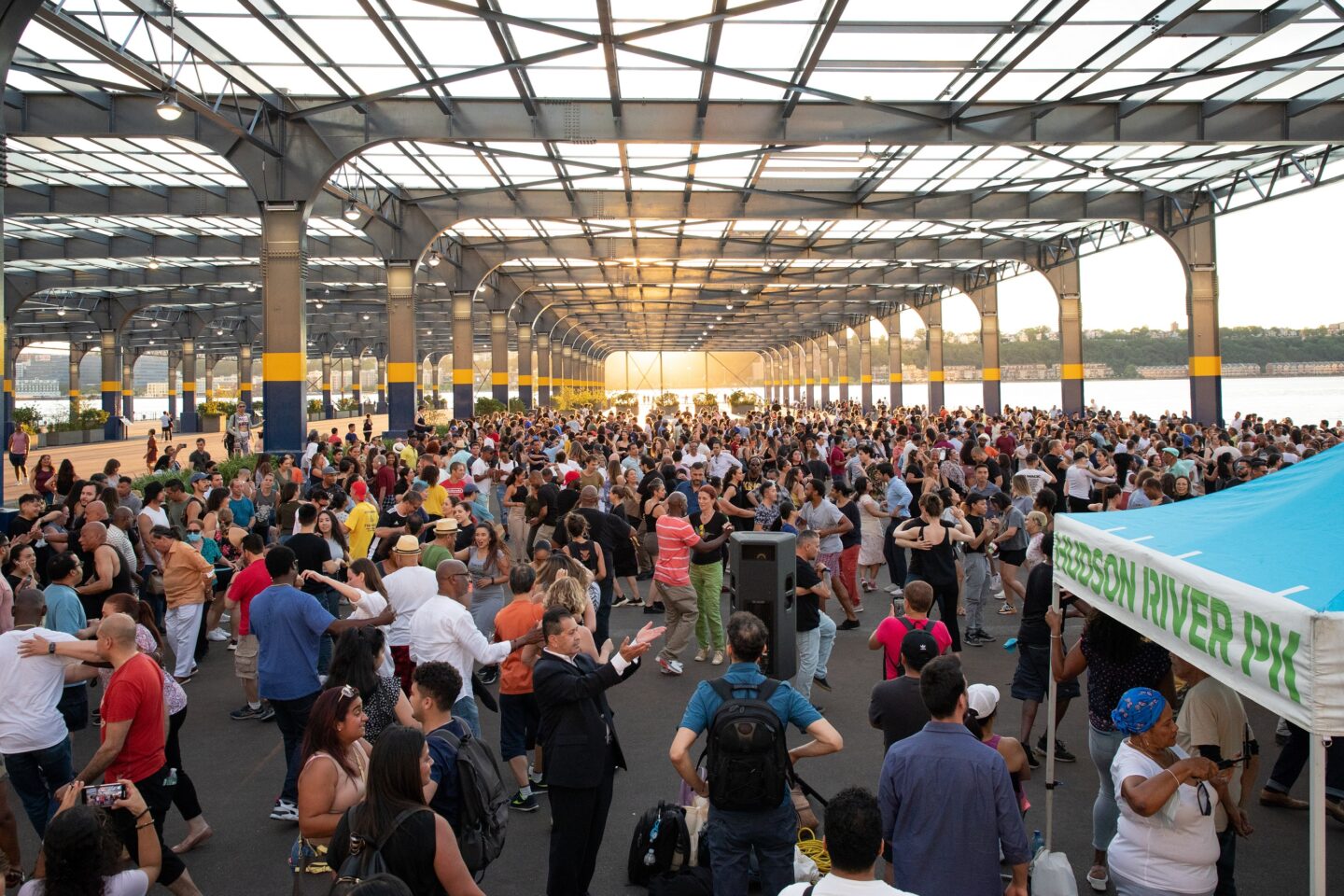 Large crowd salsa dancing at Sunset Salsa on Pier 76 in Hudson River Park