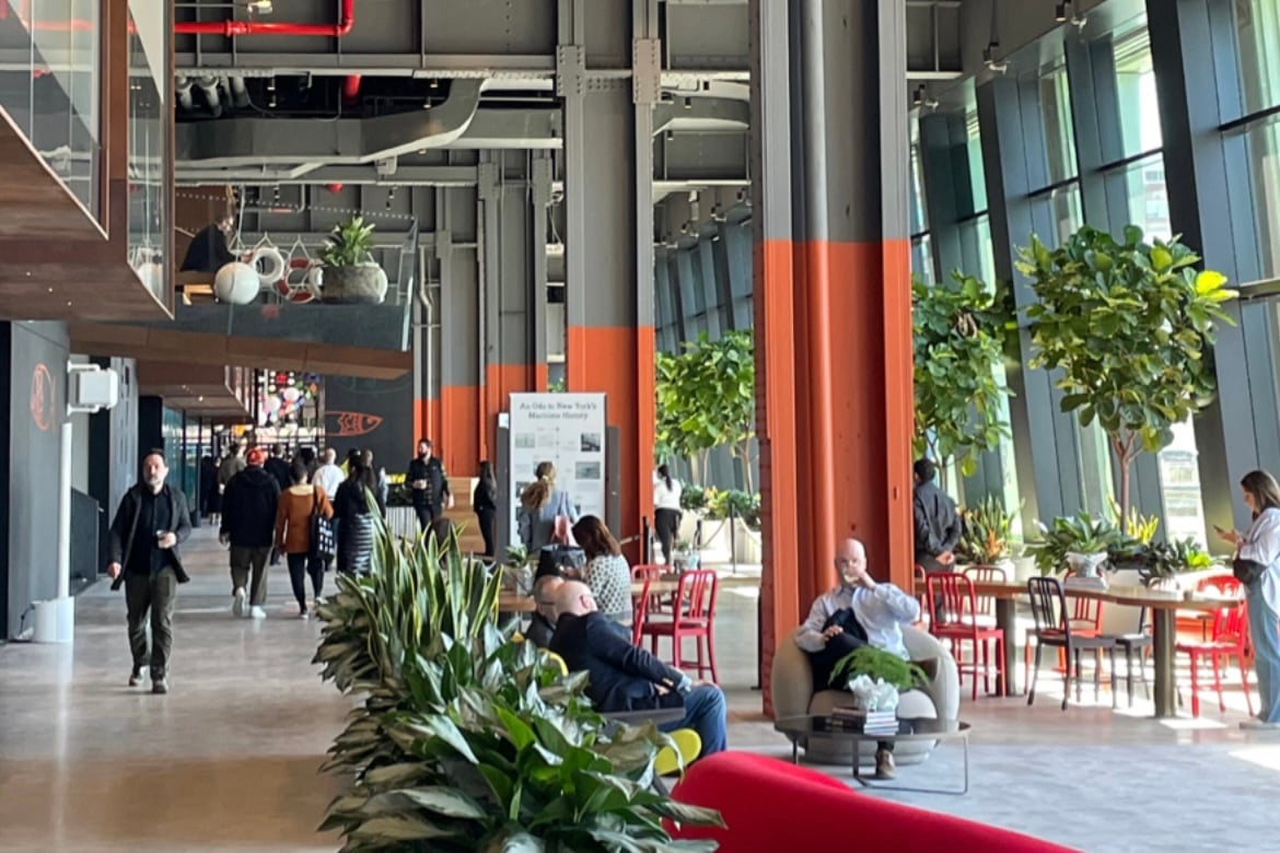 People sitting and walking through the Living Room at Pier 57