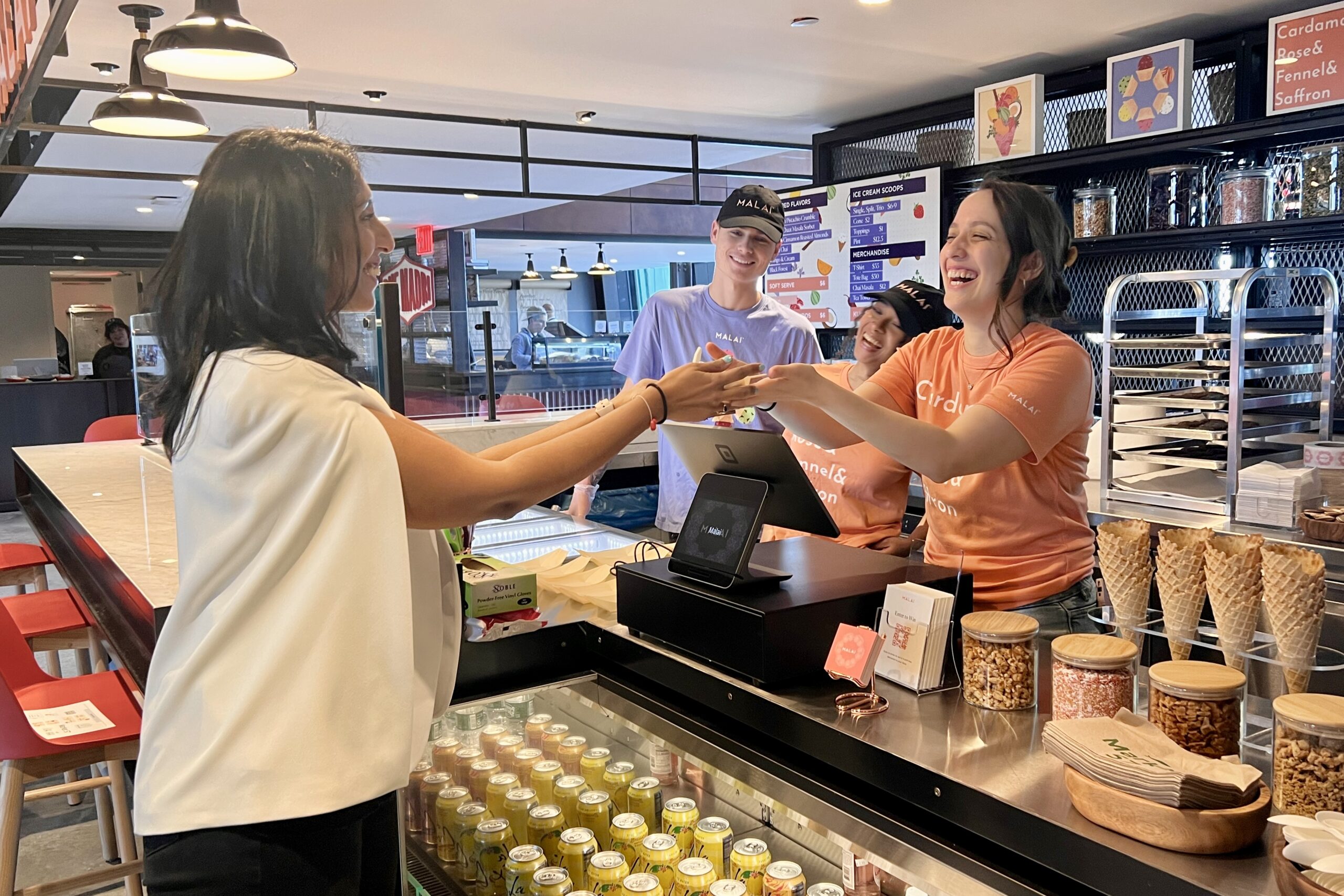 A person receiving their order at Malai at Market 57
