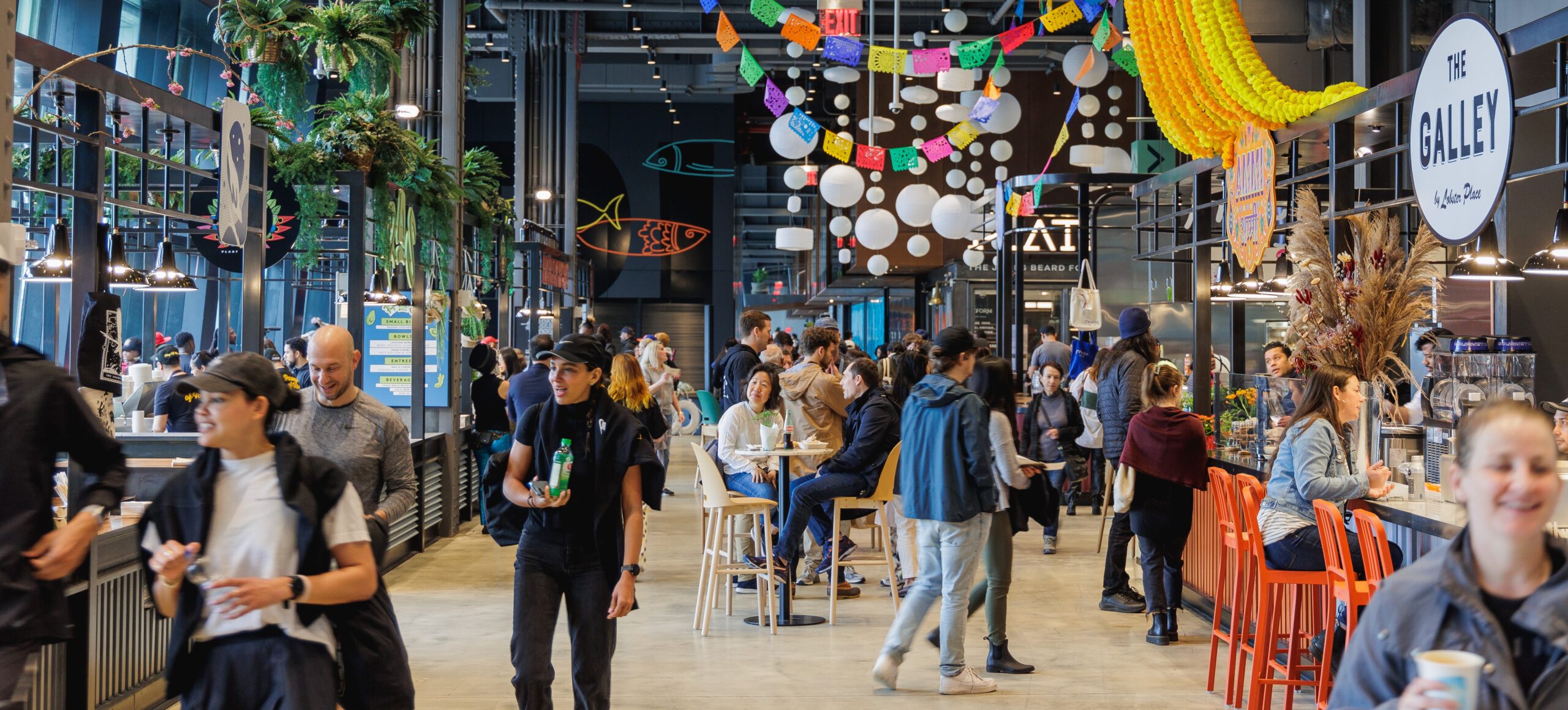 People walking and shopping at Market 57, a food hall at Pier 57