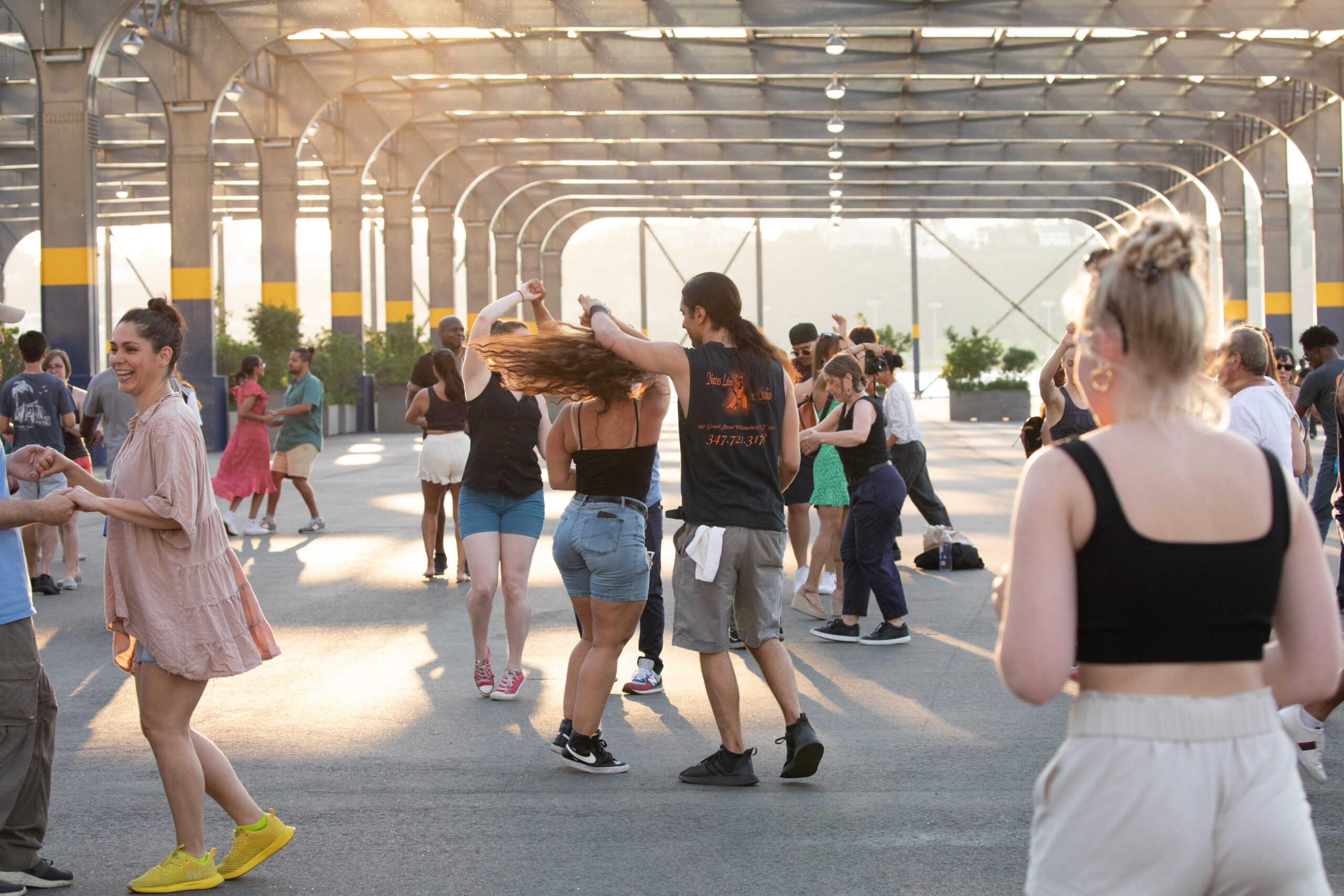 Pairs of people dancing together on Pier 76 during a Sunset Salsa class