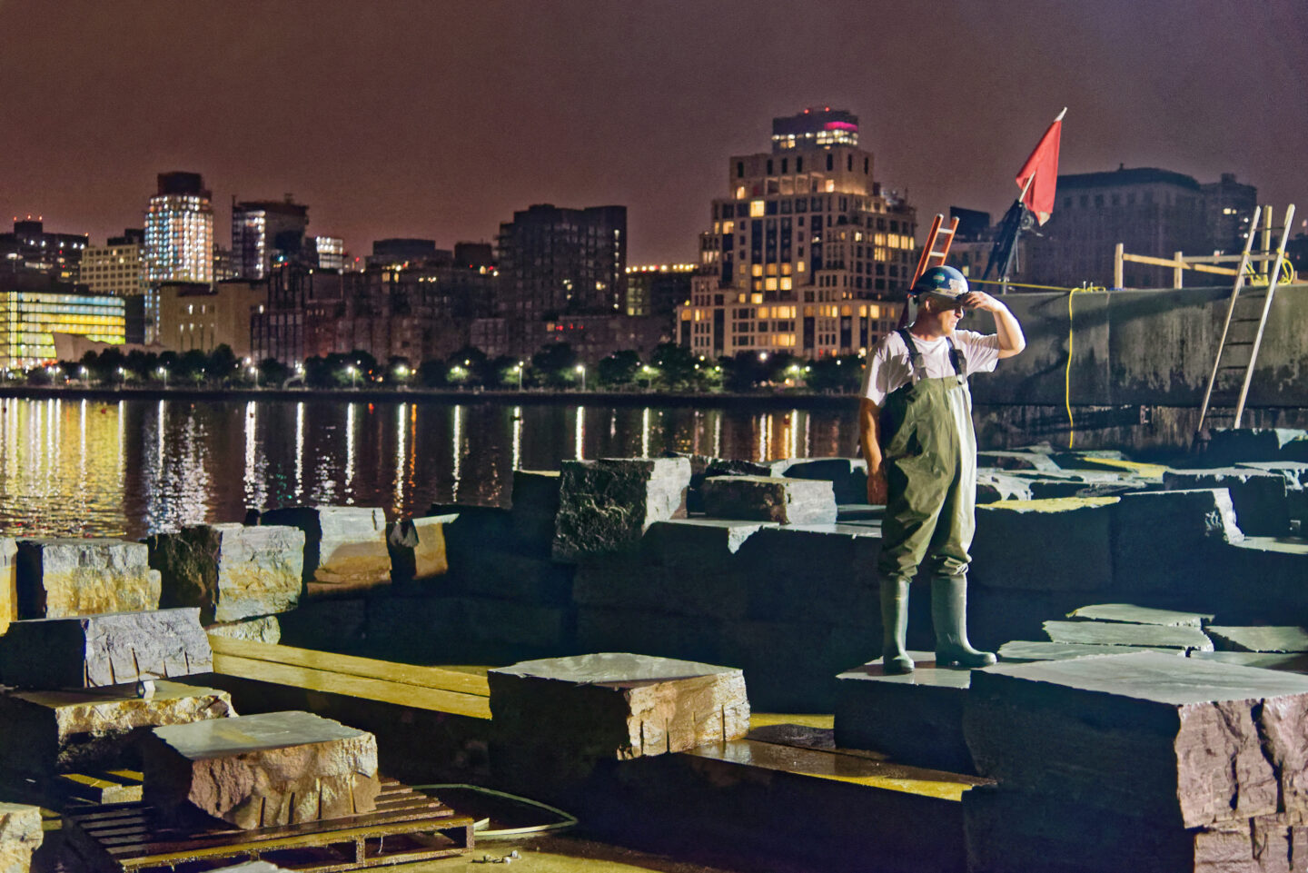 A worker looking out over the construction of Pier 26.