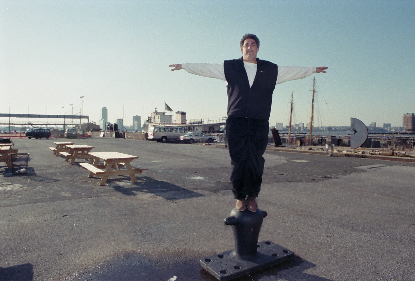 Bob Townley, executive director of Manhattan Youth, standing on top of a mooring bollard on Pier 25.
