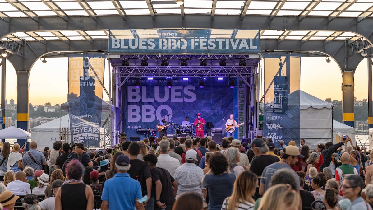 John Primer and the Real Deal Blues Band performing on stage in front of a large crowd at the Blues BBQ Festival on Pier 76