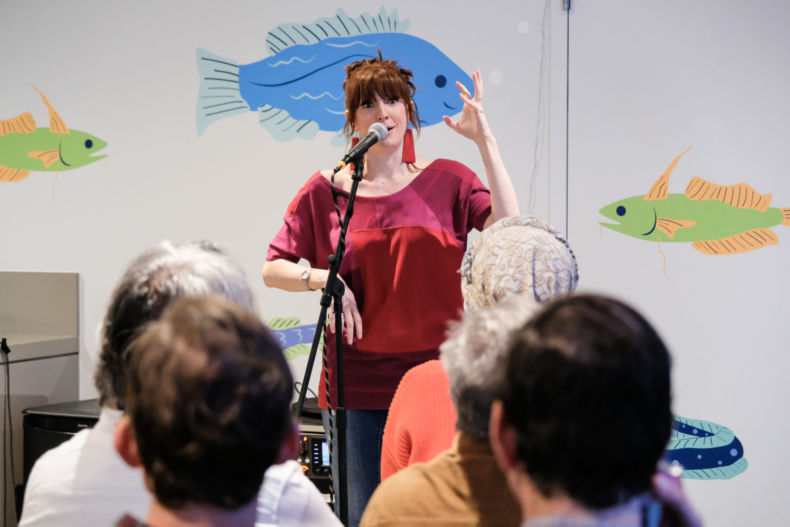 A speaker in front of an audience at a Discovery Tank event