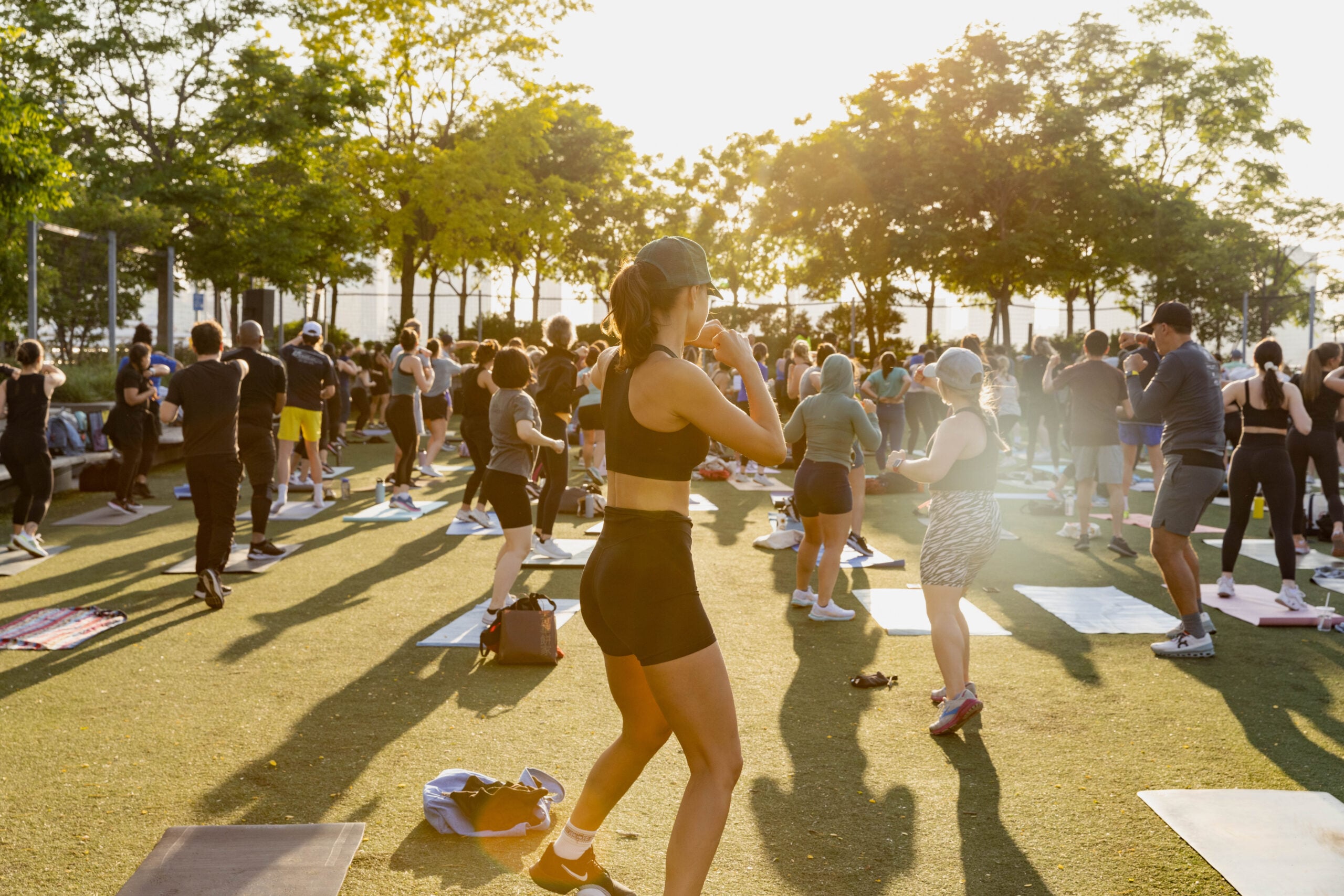 Healthy on the Hudson HIIT class participants throw punches on the Pier 25 turf field