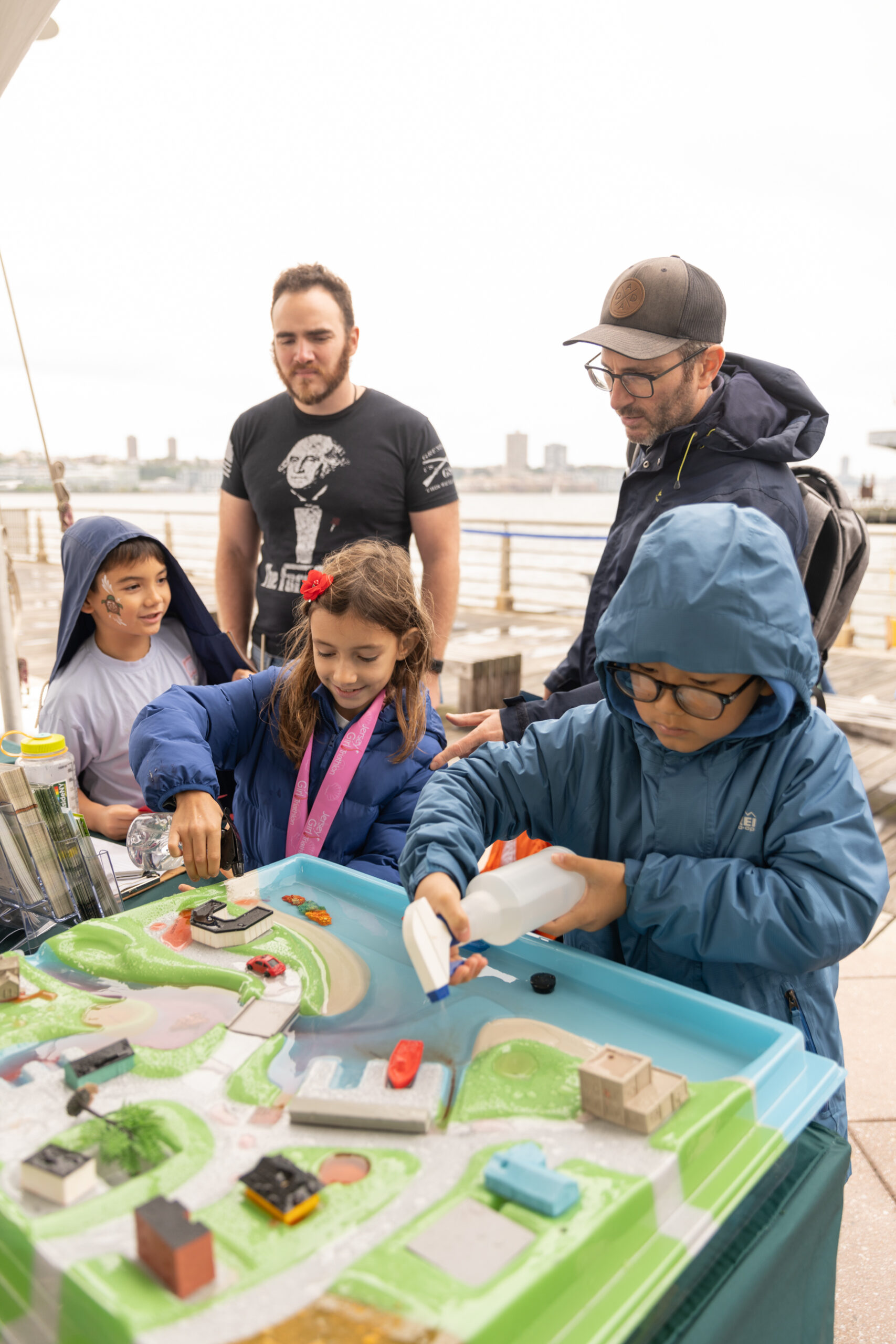 Students interact with a model of a river and learn about water flow at SUBMERGE Marine Science Festival
