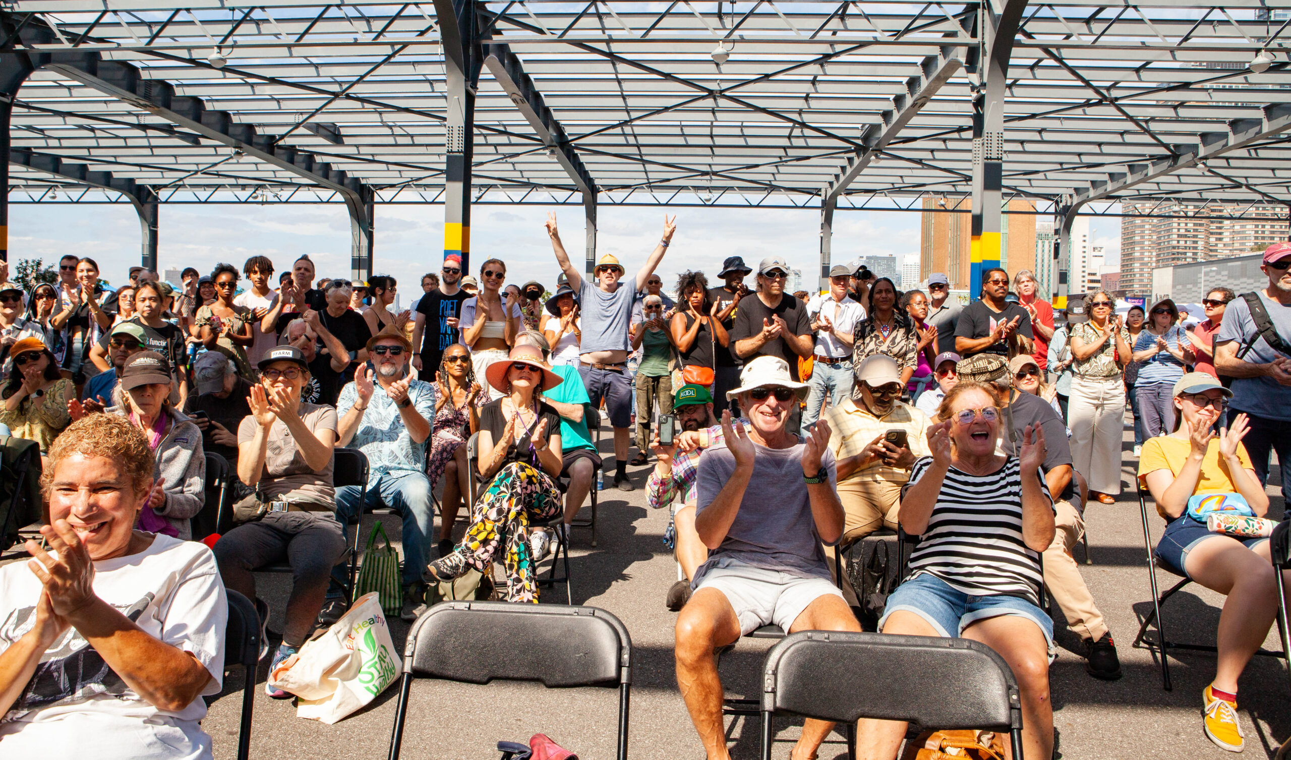 Audience members at the Blues BBQ Festival cheer after a performance
