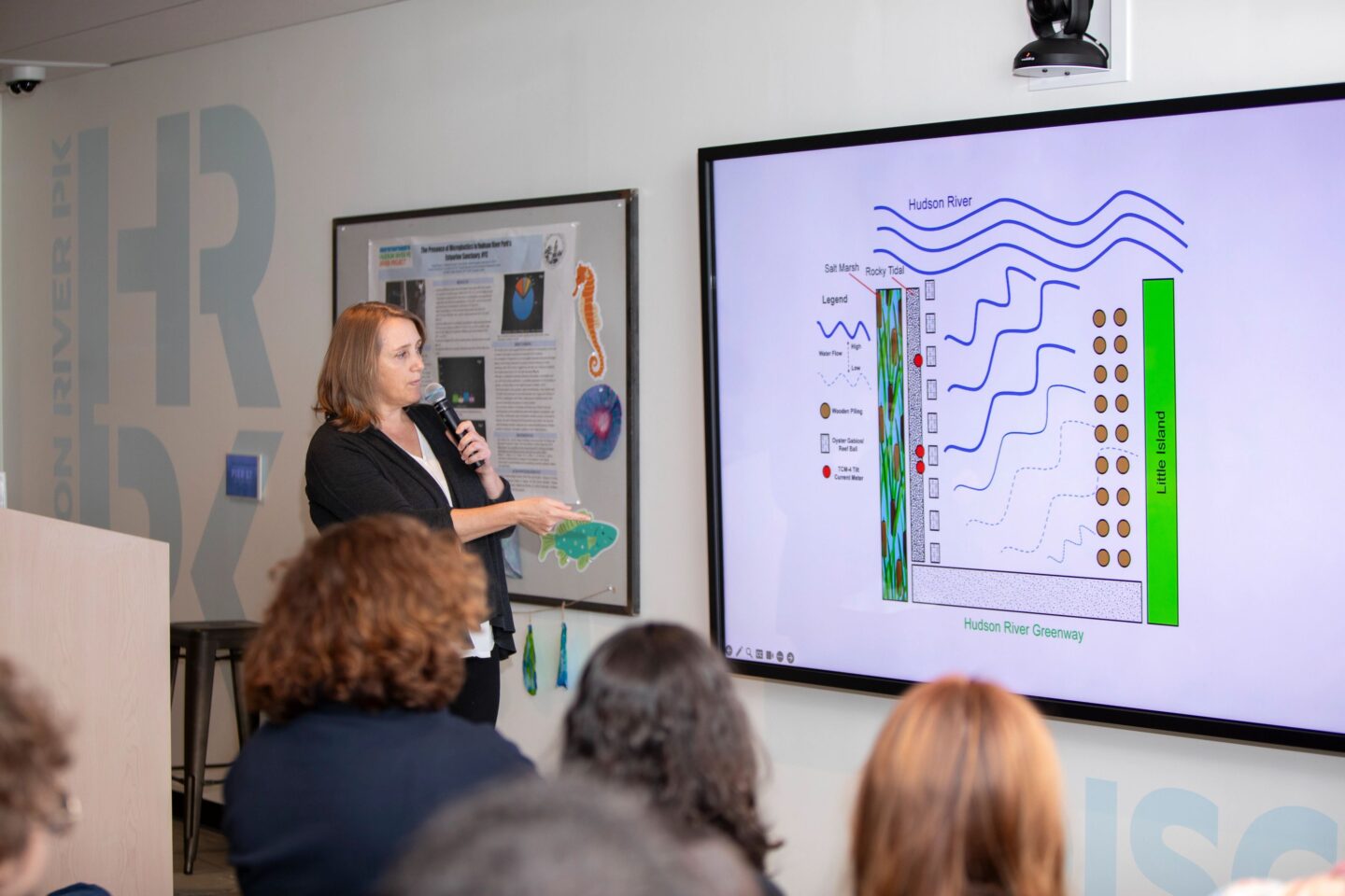 A presenter explains a slide showing the tides of the Hudson River