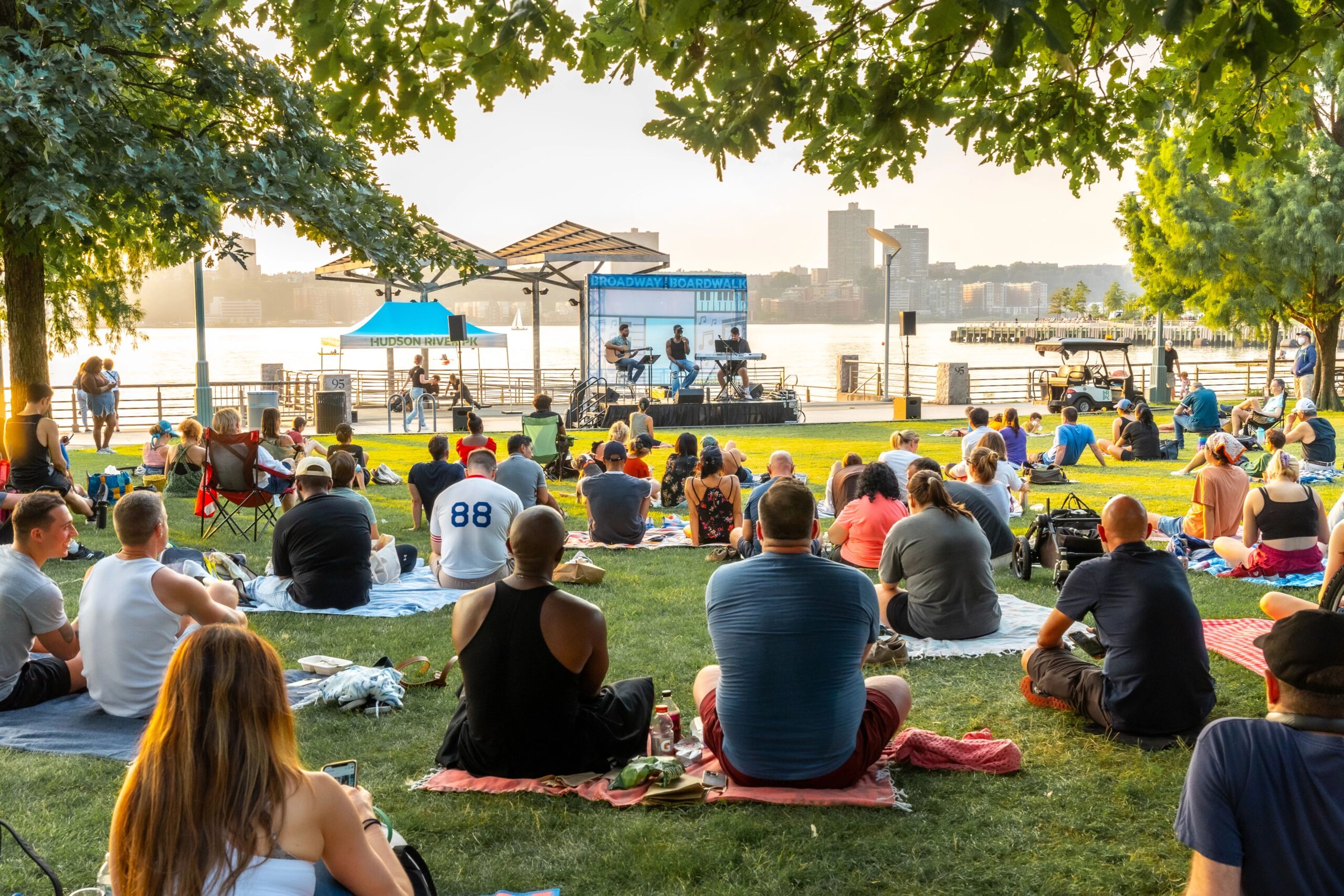 Park visitors enjoy a Broadway by the Boardwalk music performance from the lawn at Clinton Cove