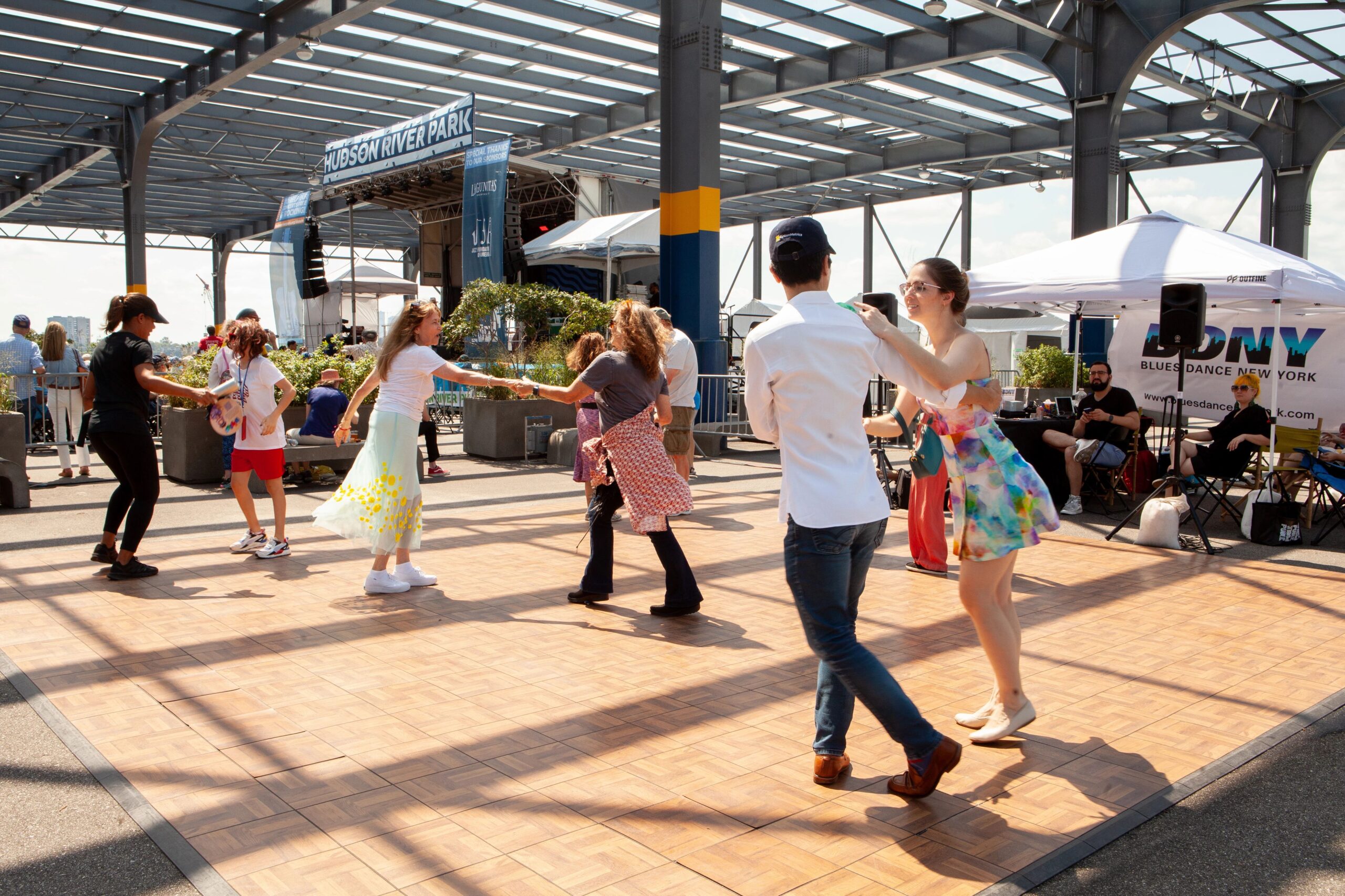 Pairs of people dancing on the parquet dance floor at the Blues BBQ Festival