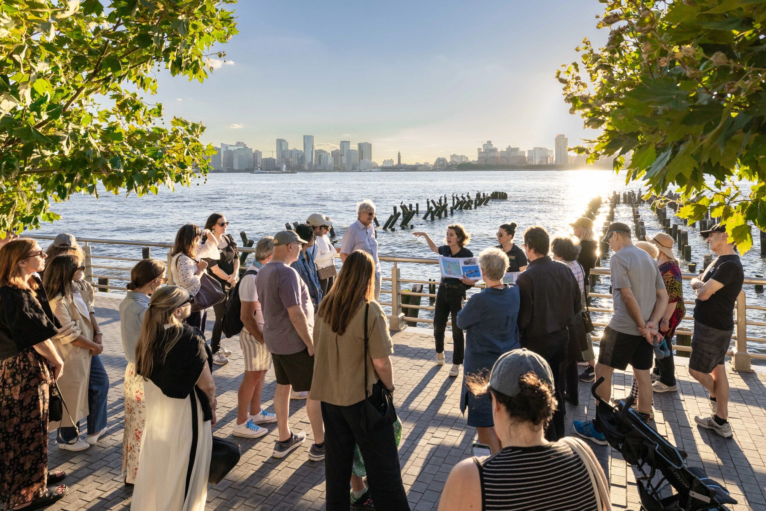 An HRPK River Project staffer leads a group on a Shoreline Strolls tour of Gansevoort Peninsula
