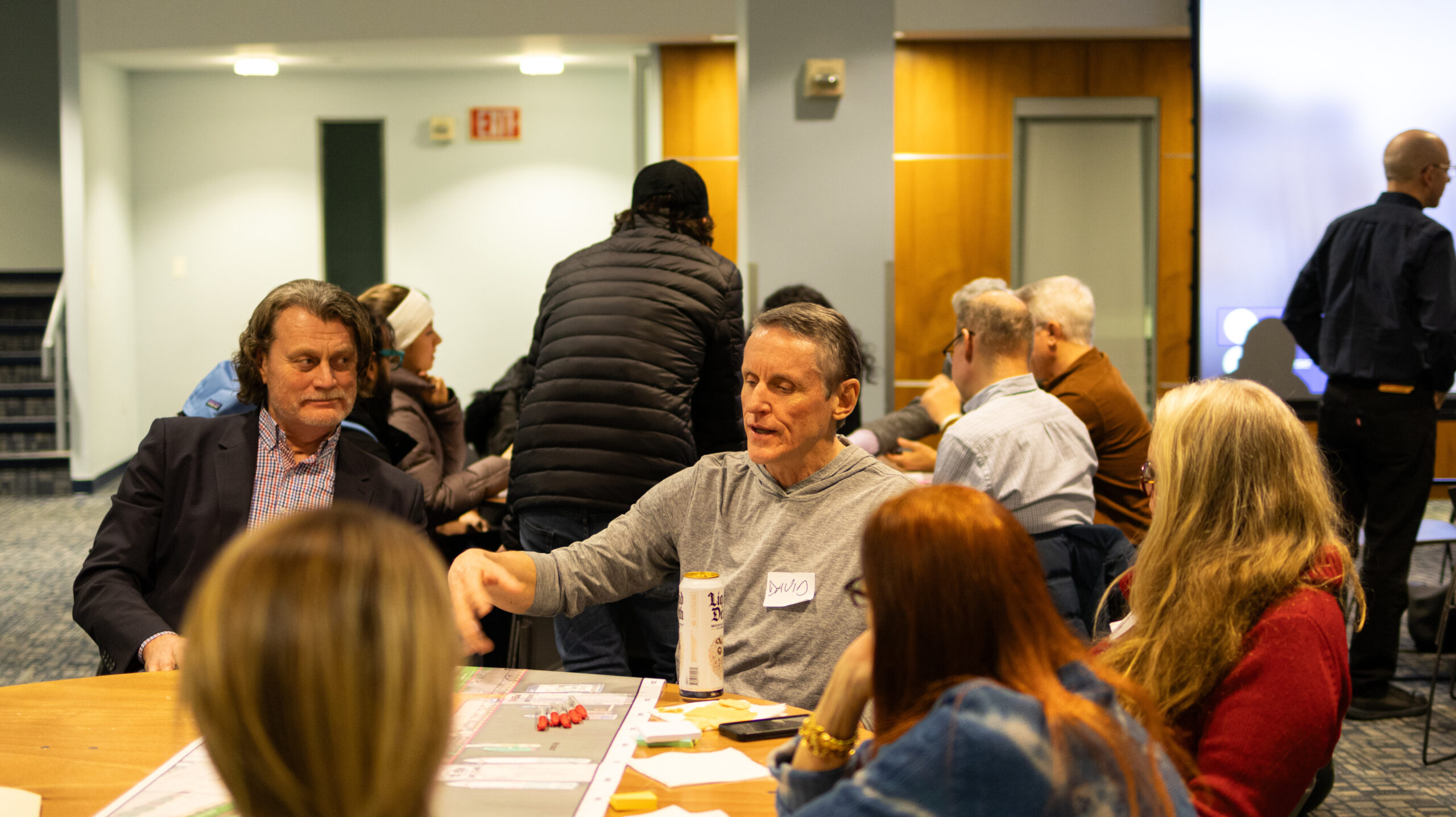 Members of the local community in a discussion at a table during a W 29–W 44 Esplanade & Landscape Engagement Meeting at the Intrepid Museum