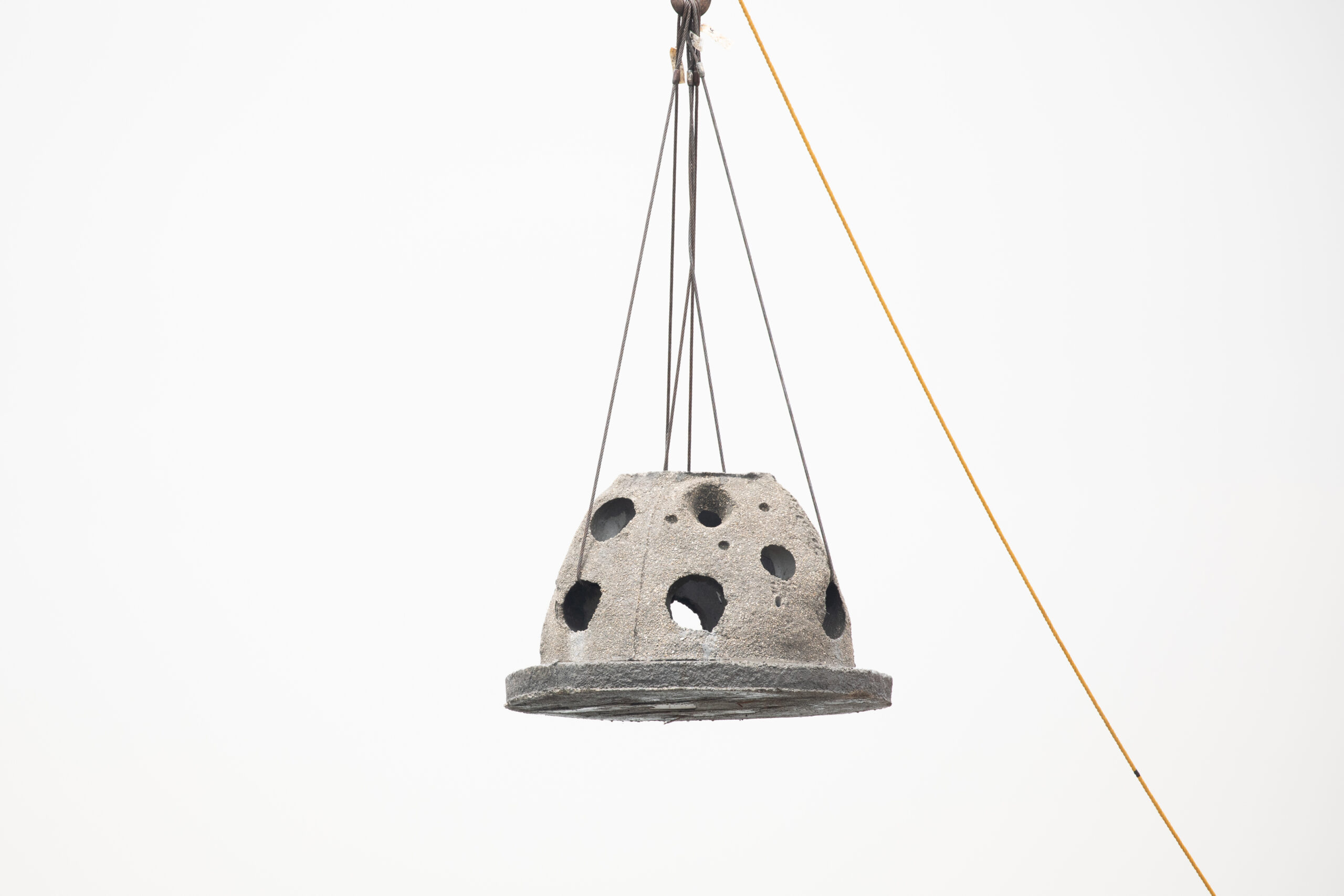 A reef ball held by cables