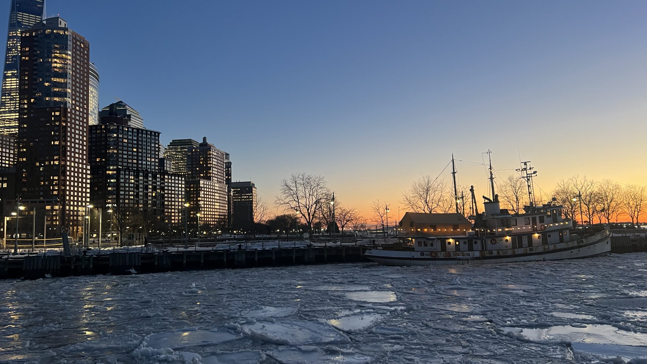 sunset over ice floes in Hudson River Park's Pier 25 and historic lighthouse tender LILAC