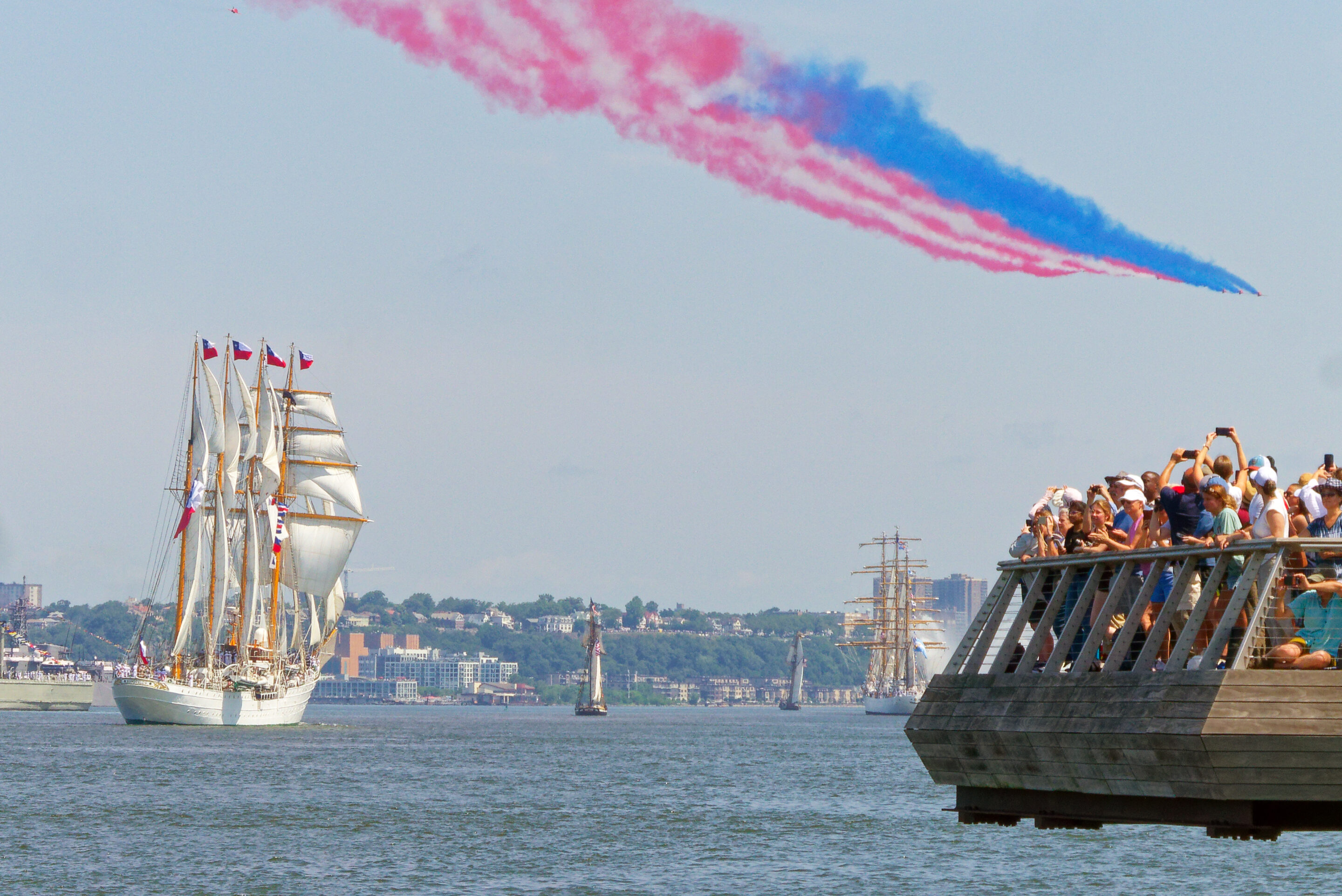 Tall ship sails by edge of Pier 26, aerial dislay above trails red white and blue